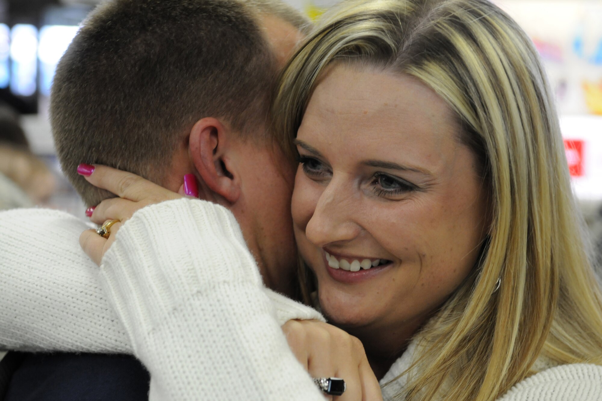 MISAWA CITY, Japan -- Shannon Day hugs her husband, Tech. Sgt. Mark Day, at the Misawa City airport Jan. 7, 2009. Sergeant Day, along with eight other 35th Civil Engineer Squadron personnel, arrived back home from a six-month deployment to Balad, Iraq. (U.S. Air Force photo by Senior Airman Jamal D. Sutter)