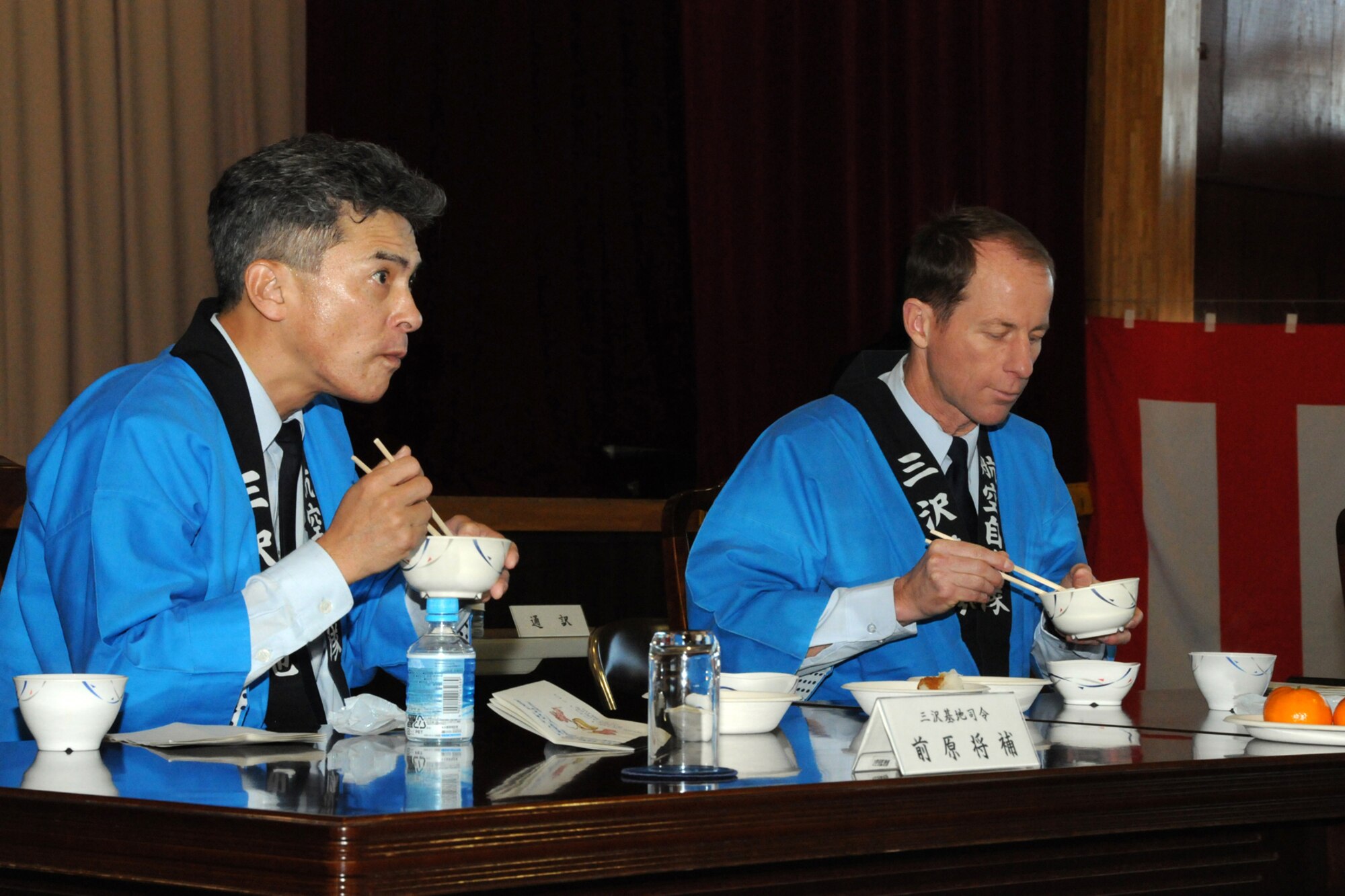 MISAWA AIR BASE, Japan -- Maj. Gen. Hiroaki Maehara, 3rd Air Wing commander, and Col. David Stilwell, 35th Fighter Wing commander, taste mochi made during the annual rice pounding ceremony at the Japan Air Self-Defense Force gymnasium Dec. 17, 2008. Though eaten throughout the year, mochi is traditionally eaten on New Year's Day and is believed to prevent disaster in the upcoming year. (U.S. Air Force photo by Senior Airman Jamal D. Sutter)