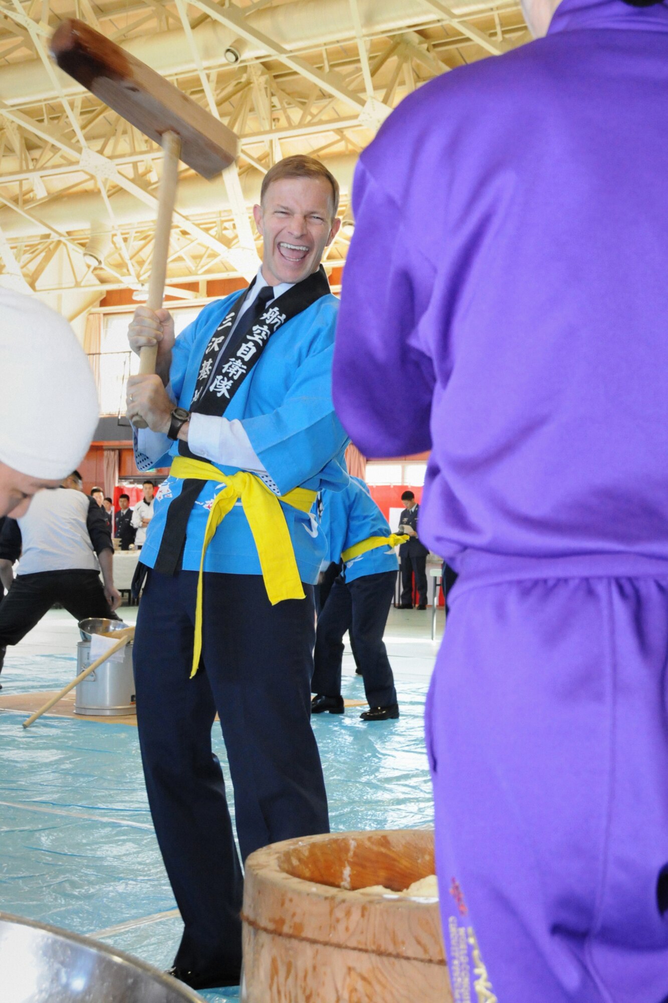 MISAWA AIR BASE, Japan -- Col. Robert Craig, 35th Fighter Wing vice commander, pounds rice during an annual ceremony at the Japan Air Self-Defense Force gymnasium Dec. 17, 2008. The process of pounding rice requires teamwork, thus creating strong ties between those participating. (U.S. Air Force photo by Senior Airman Jamal D. Sutter)

