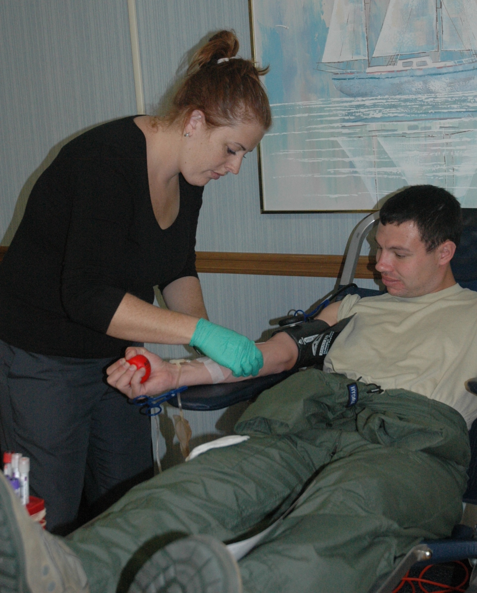 Courtney Davis, of the Armed Services Blood Program, prepares 2nd Lt. Joseph Tucker, 325th Air Control Squadron air battle management student, for his blood donation at the Community Activities Center today.  (U.S. Air Force photo by Airman 1st Class Veronica McMahon)