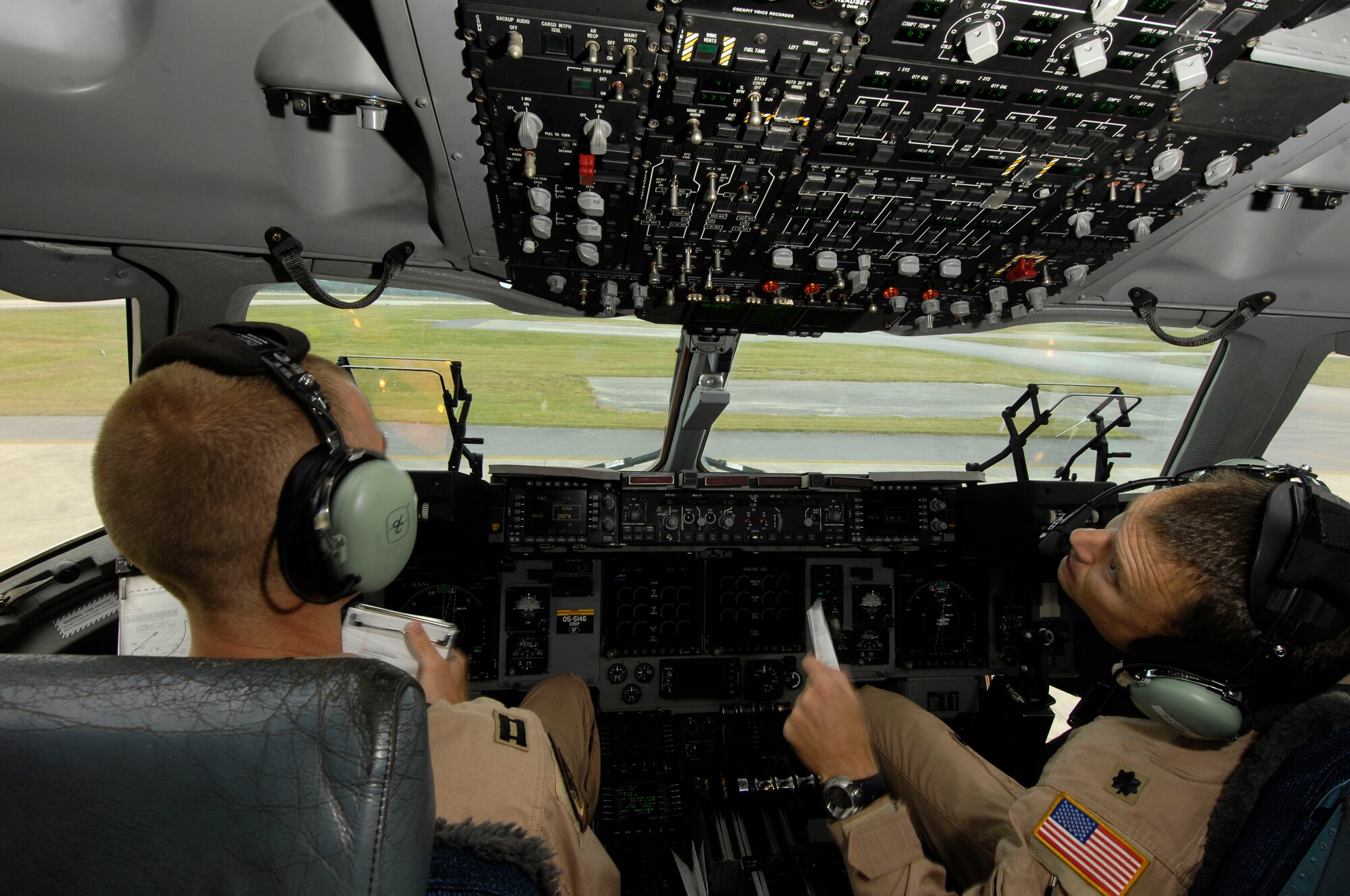 Airmen prepare a C-17 Globemaster III to take off Dec. 29 at Kadena Air Base, Japan. The crew picked up a mine-resistant ambush-protected vehicle to be taken to Afghanistan. (U.S. Air Force photo/Tech. Sgt. Cohen A. Young) 
