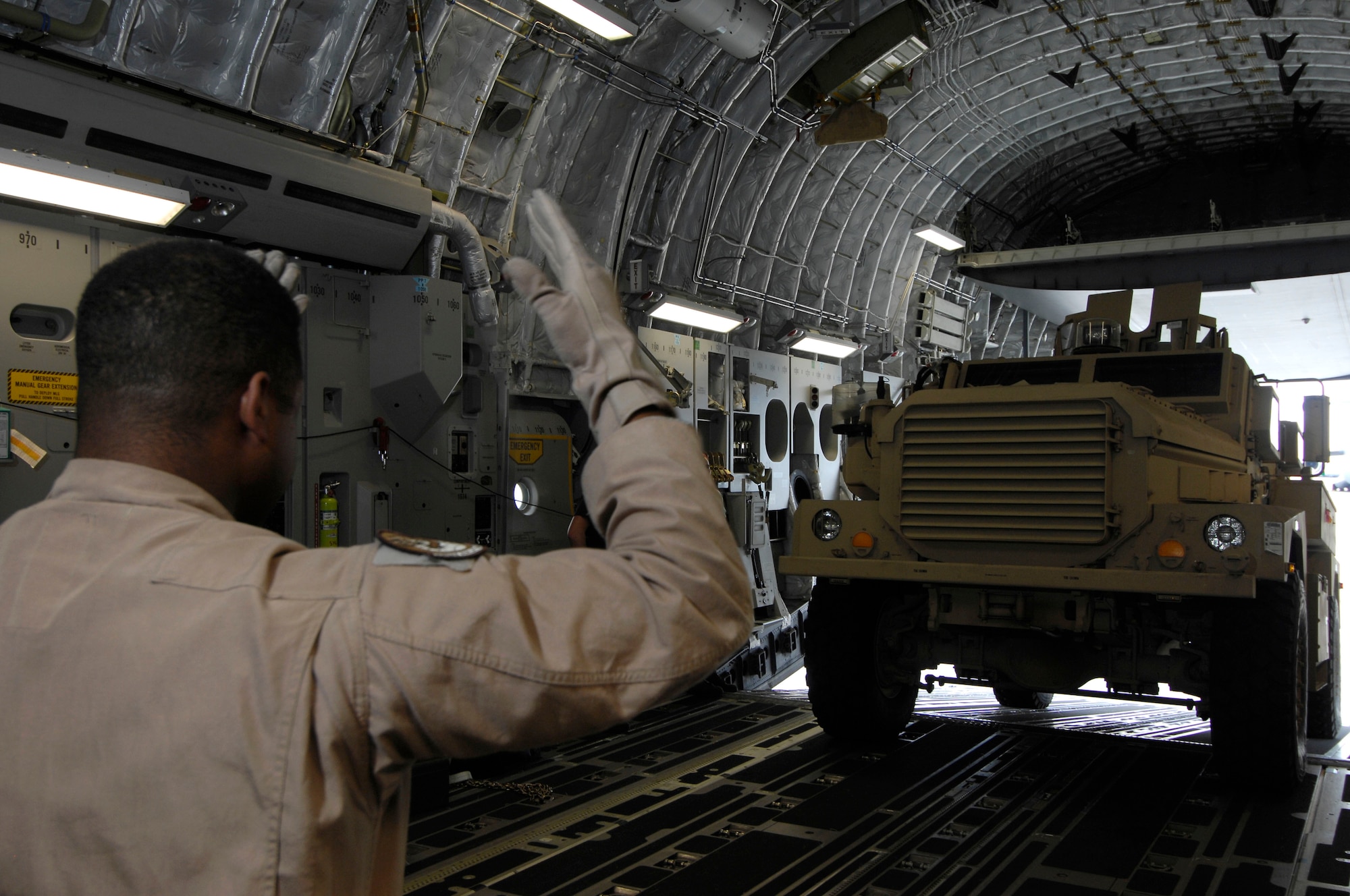 Tech. Sgt. Andre Stollenwer guides a Marine-owned mine-resistant ambush-protected vehicle into a C-17 Globemaster III Dec. 29 at Kadena Air Base, Japan. Sergeant Stollenwer is a 535th Airlift Squadron loadmaster from Hickam Air Force Base, Hawaii. He is a native of Birmingham, Ala. (U.S. Air Force photo/Tech. Sgt. Cohen A. Young) 
