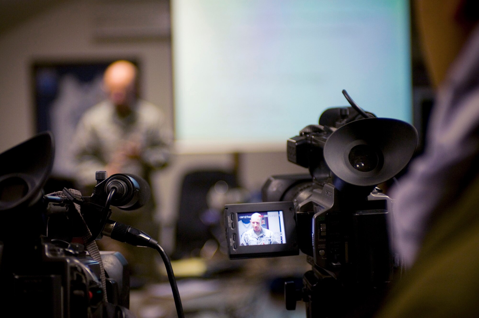 A cameraman captures a close-air support briefing from Brig. Gen. James M. "Mike" Holmes Jan. 5 at Bagram Airfield, Afghanistan. General Holmes is the 455th Air Expeditionary Wing commander. The 455th AEW hosted an Afghan Media Day to inform the local populace about the Air Force's role in Afghanistan. (U.S. Air Force photo/Staff Sgt. Samuel Morse)
