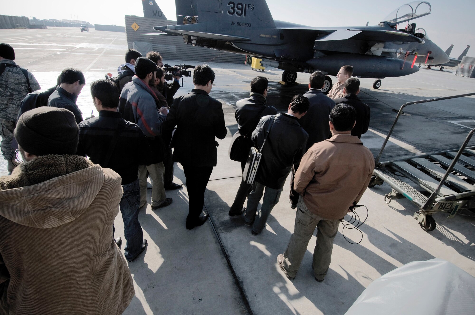 Members of the Afghan media gather for a tour of an F-15E Strike Eagle Jan. 5 at Bagram Airfield, Afghanistan. Fourteen members of Afghan news agencies attended the 455th Air Expeditionary Wing Afghan Media Day to learn more about close-air support. (U.S. Air Force photo/Staff Sgt. Samuel Morse)

