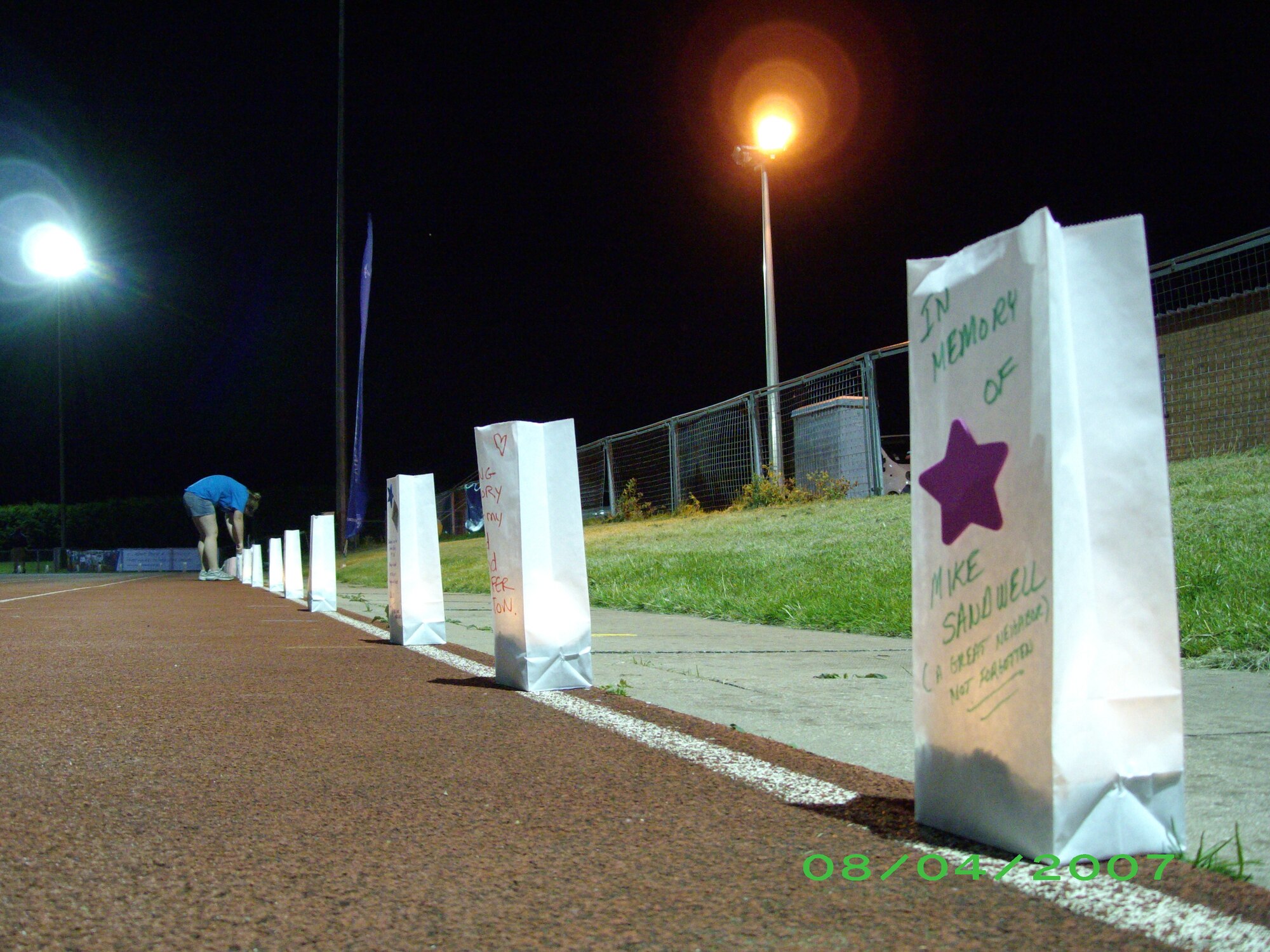 SCOTT AIR FORCE BASE, Ill.--One of the favorite ceremonies for both the Kaelin Family and the United We Stand Against Cancer I and II teams is the Lunminaria Ceremony. In this ceremony bags with candles are decorated and placed alphabetically around the track in honor or in memory of cancer victims. The names of all the people the bags are for are also read, which can be as many as 800 people. (Courtesy photo) 