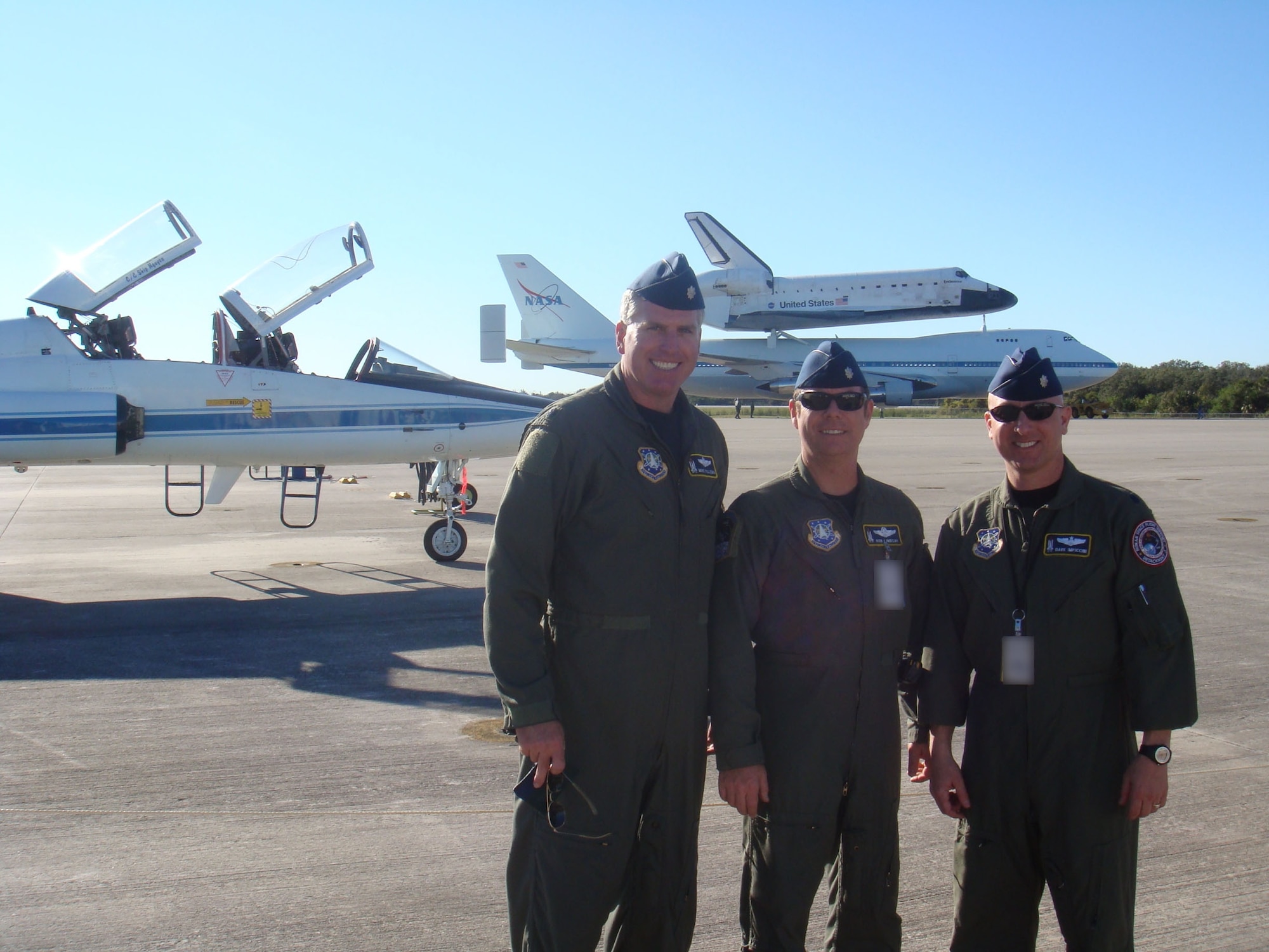 Lt. Col. Mike Tillema, Lt. Col. Robert Lindsay, Lt. Col. Dave Impiccini with the shuttle after its successful landing at Kennedy Space Center. (U.S. Air Force photo courtesy of Lt. Col. Mike Tillema)