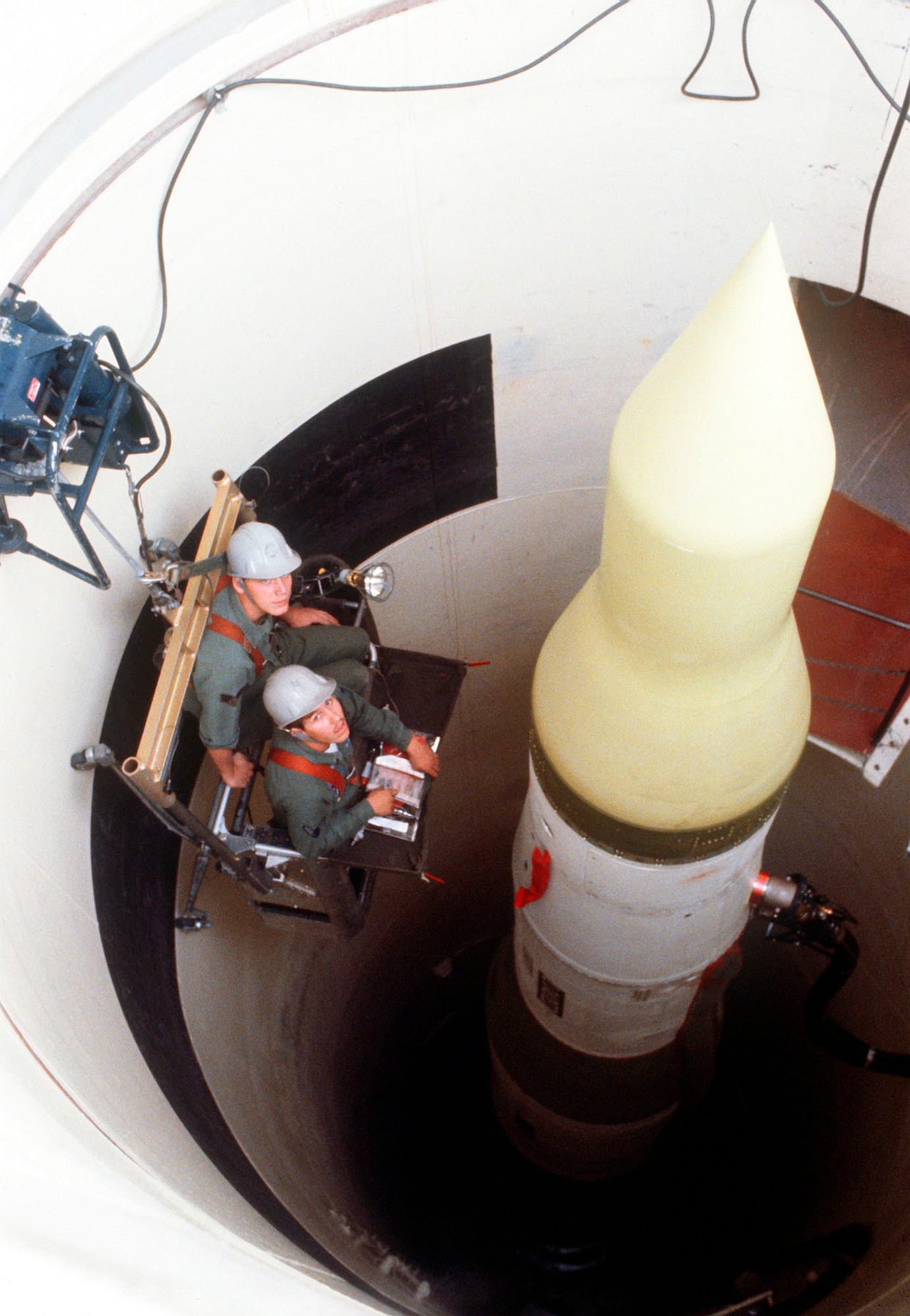Missile maintainers perform electrical work in a silo at Whiteman AFB, Mo., 1980. (U.S. Air Force photo)