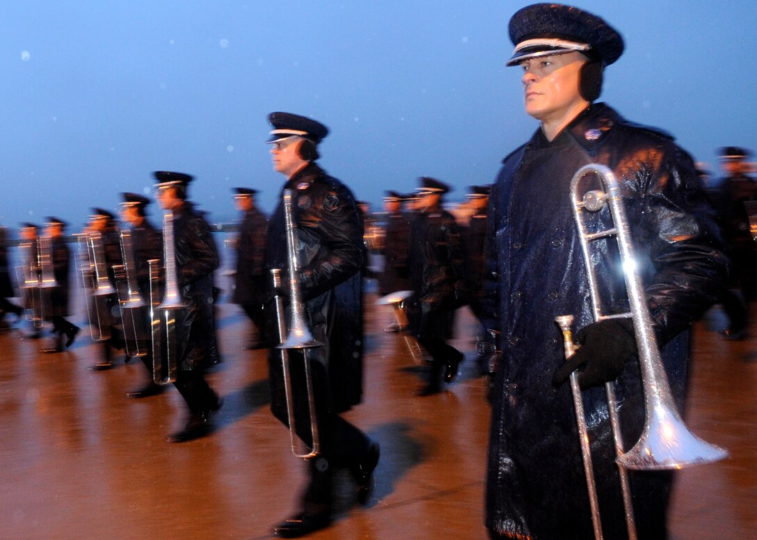 Master Sergeant Ryan Haines marches  in the January morning rain with the 99 piece Air Force band in preparation for the Inauguration of President-elect Barak Obama.  They are preparing for real-world weather scenarios.  The practice took place on the Andrews Air Force Base flightline, Jan. 7, 2009.  (US Air Force photo/Master Sgt. Cecilio M. Ricardo) 