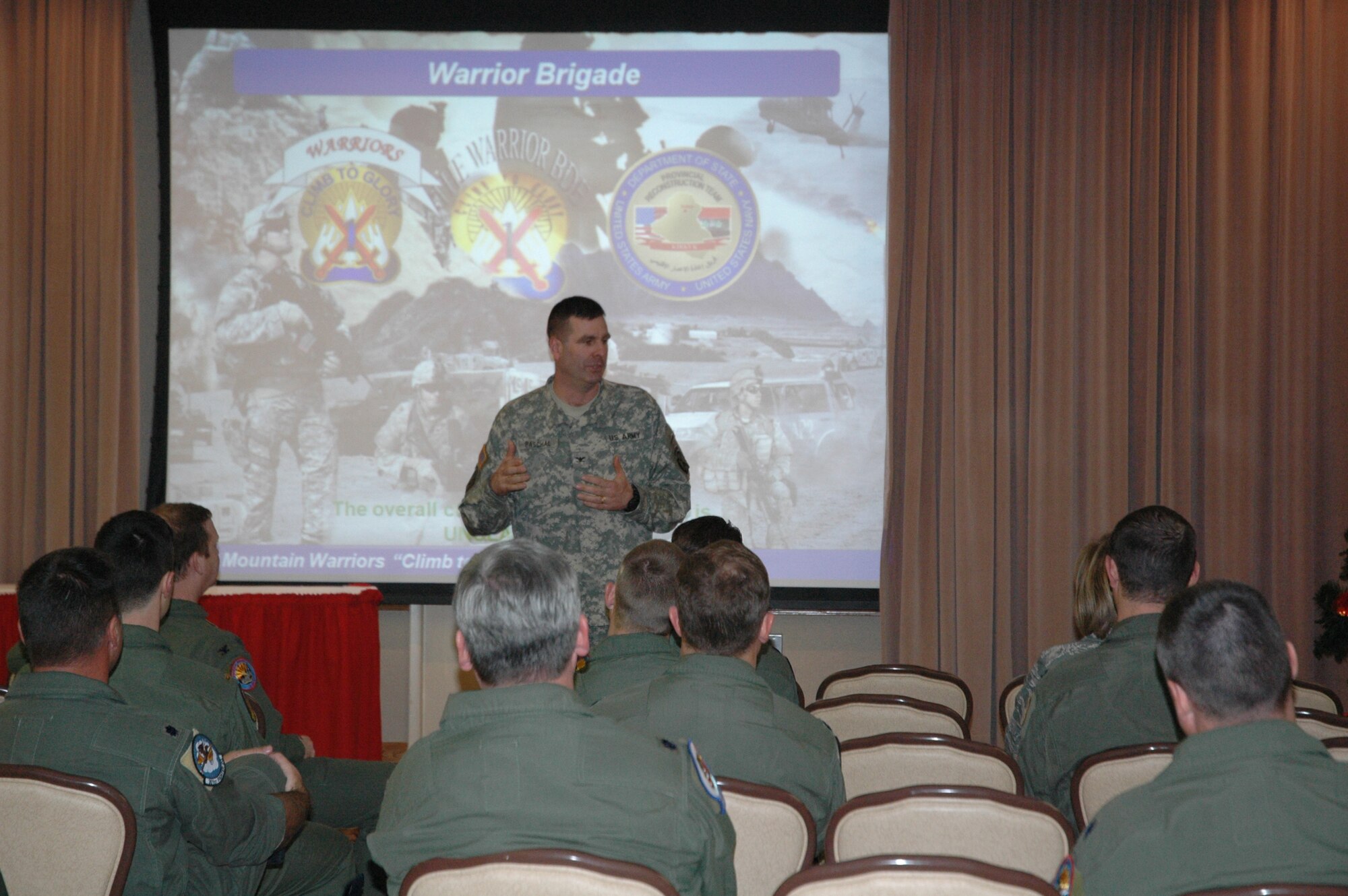 Army Col. David Paschal, Commander, 1st Brigade Combat Team, 10th Mountain Division and Fort Drum, N.Y., speaks to a group of 944th Fighter Wing members Dec. 16, 2008, during his visit to Luke. Colonel Paschal was deployed with Col. Richard Scobee, 944th Fighter Wing commander, in Iraq. During his 14 months overseeing Kirkuk Provence, Colonel Paschal and his Army Soldiers reduced violence in the area 70 percent. Colonel Paschal told of successes with the Iraqis in the area and the partnerships between the Air Force, the Army and Coalition Forces. (U.S. Air Force photo/Tech. Sgt. Susan Stout)