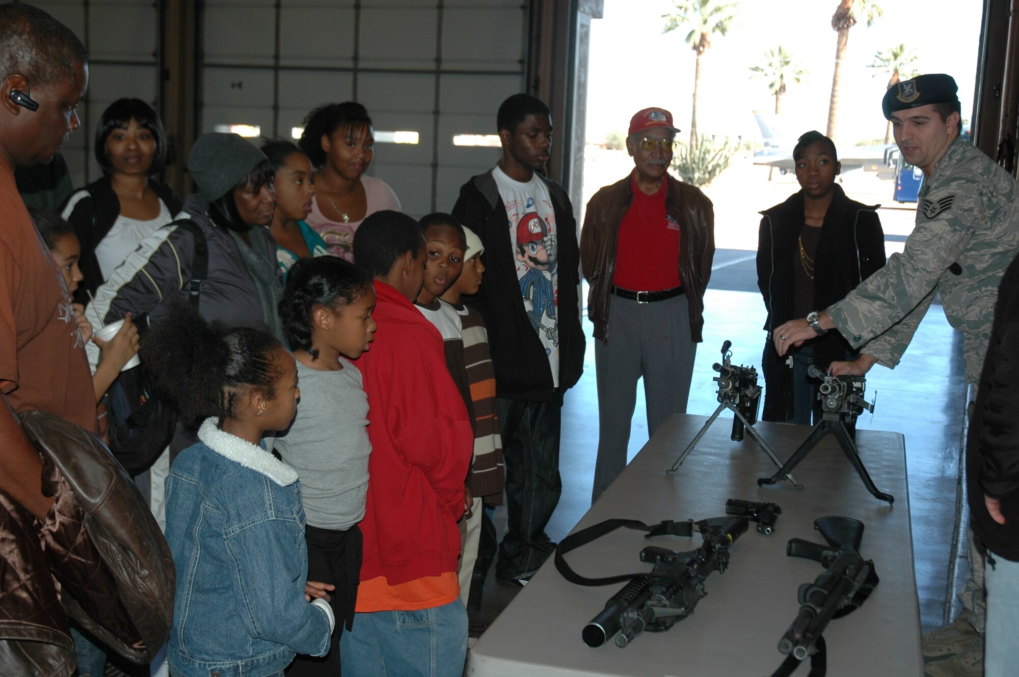 Students with the Valley Christian Academy visit Luke Air Force Base, Ariz., during their fall break Dec. 30, 2008. During their tour, the students toured the fire department and got to see an F-16 up close as part of the 944th Fighter Wing's second annual Career Day. Other demonstrations were provided by the 56th Security Forces Squadron and the 56th Civil Engineer Squadron Explosive Ordnance Disposal flight. Lt. Col. (ret.) Robert Ashby, an Original Tuskegee Airman, was also in attendance to discuss his experiences of desegregating the Air Force during World War II. The students ended the day with a basketball clinic at the fitness center. (U.S. Air Force photo/Tech. Sgt. Susan Stout)