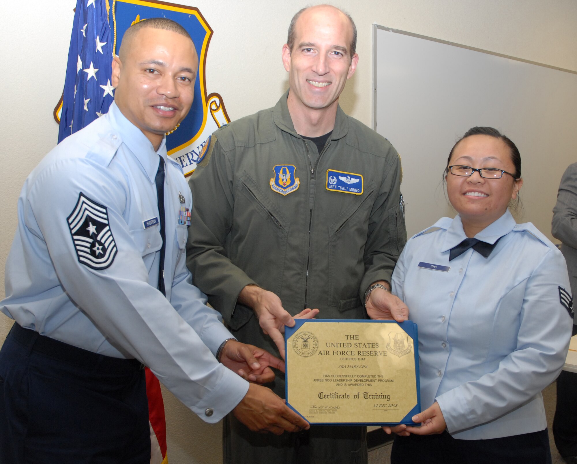 BEALE AIR FORCE BASE, Cailf. -- The 940th Air Refueling Wing's Airman of the year, Senior Airman Mary Cha receives her Air Force Leadership Development Course Certificate of Completion from 940ARW Commander Col. Jeffery "Sal" Mineo and Command Chief of the 940th ARW Jason Henderson during a graduation ceremony here Dec. 12, 2008. (U.S. Air Force Photo/ Master Sgt. Ellen Hatfield)