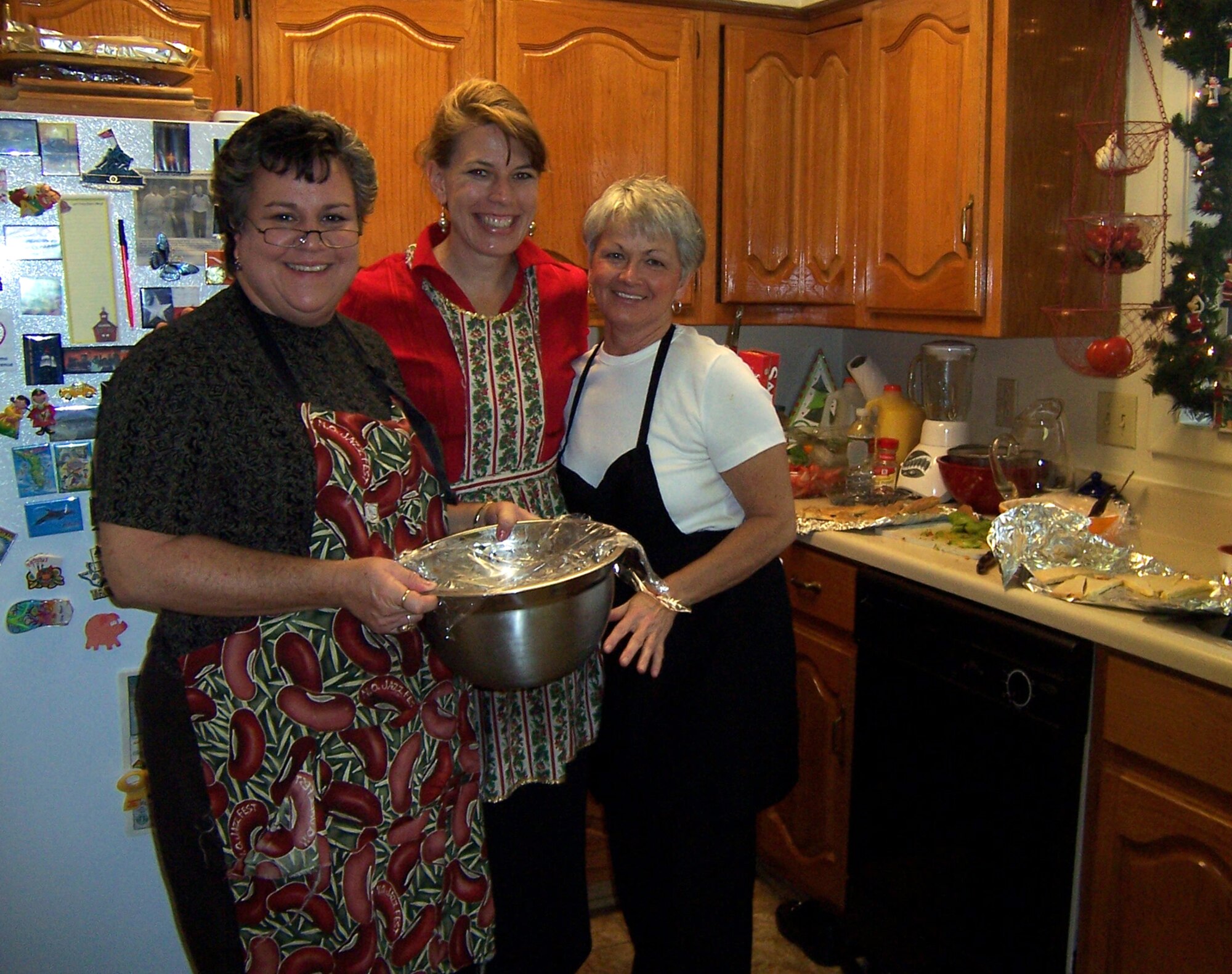 Cooks Dede Johnson, Leslie Watkins and Diane Clardy take time out to smile as they prepare food for the 14th Flying Training Wing commander’s New Year Reception Sunday. Colonel Roger Watkins, 14th Flying Training Wing commander, and his wife Leslie hosted more than 140 base, government and community leaders in their home to usher in the 2009. (U.S. Air Force photo)