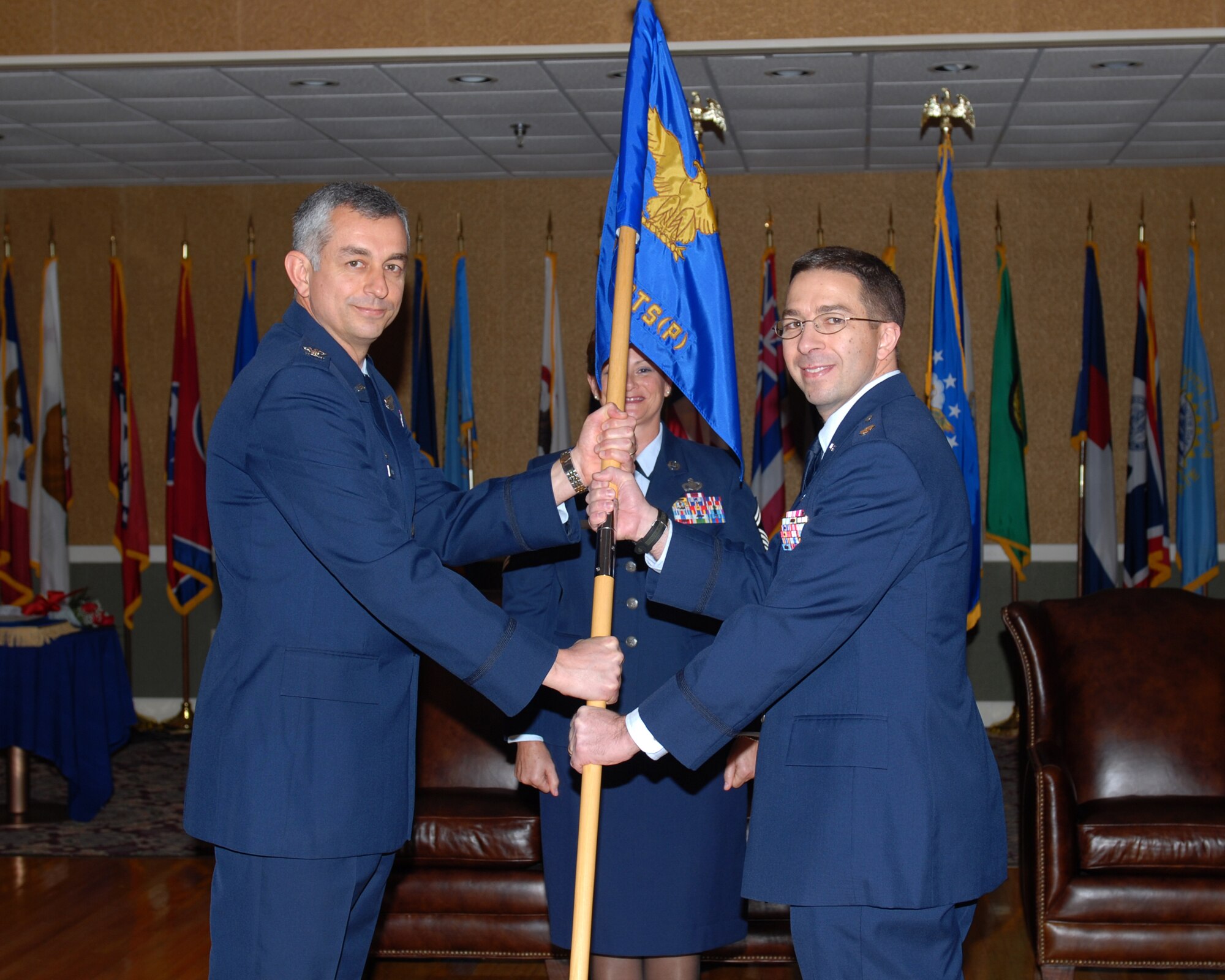 Colonel Roger Watkins, 14th Flying Training Wing commander, presents Major Brian Heaps the 14th Comptroller-Contracting Squadron (Provisional) guidon at the 14th CPTS-CONS (P) change of command ceremony Dec. 18, 2008. Maj. Heaps was previously at the US Army Command and General Staff College, Fort Leavenworth, Kan.. (U.S. Air Force photo by Melissa Duncan) 