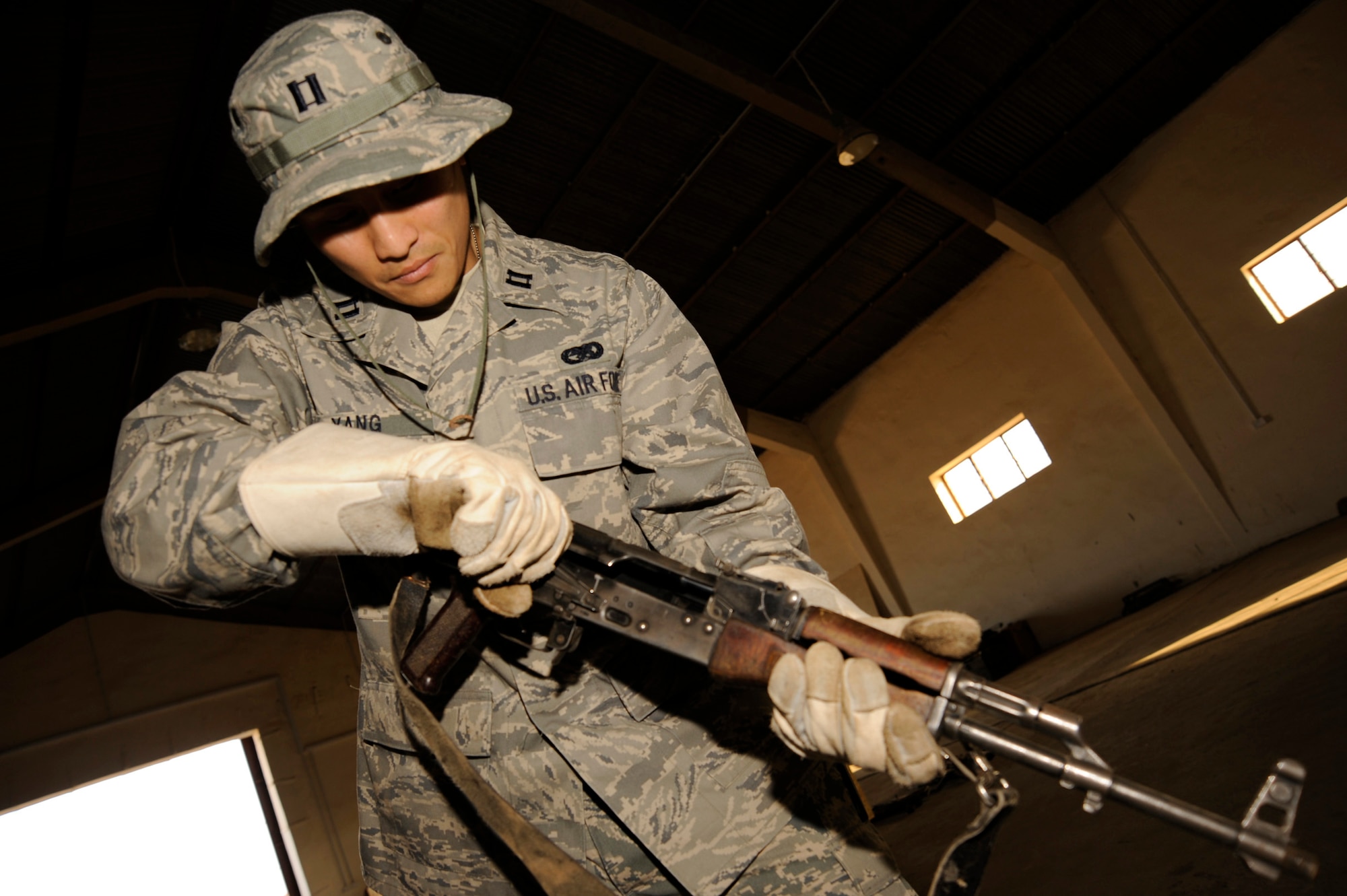 Capt. Ted Yang ensures an AK-47 rifle is cleared before packing it to be shipped at Taji Military Base, Iraq. Captain Yang is the J4 Taji liaison officer. He is a native of Fresno, Calif., and deployed from Whiteman Air Force Base, Mo. (U.S. Air Force photo/Staff Sgt. Paul Villanueva II) 
