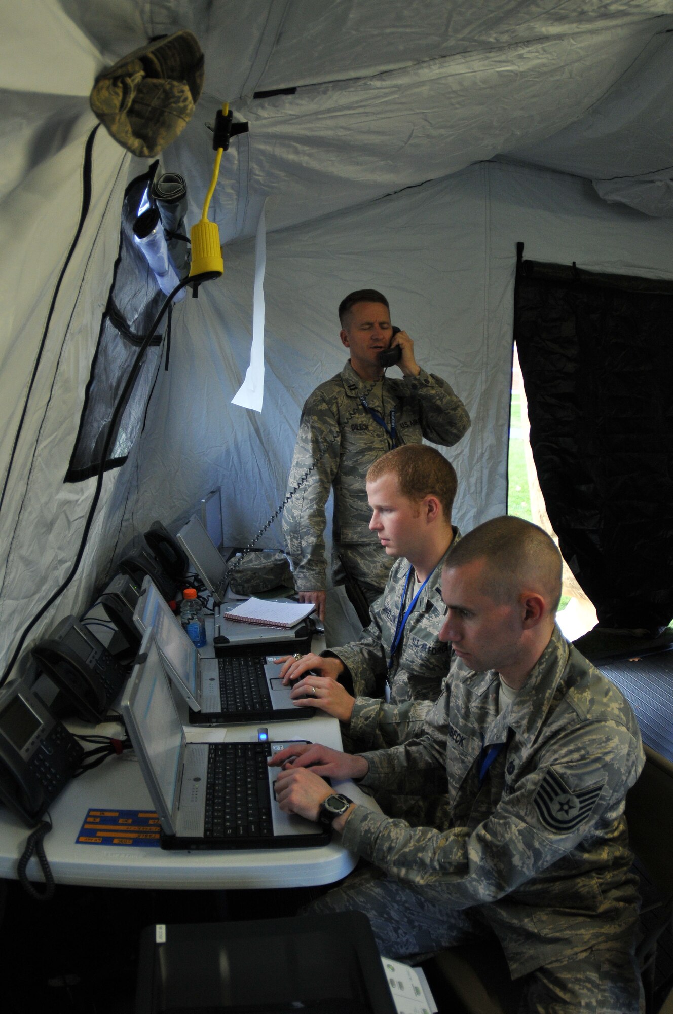 Airmen from the 267th Combat Communications Squadron work in the Joint Incident Site Communications Capability tent at the Sandwich, Mass., flu clinic, Nov. 14.