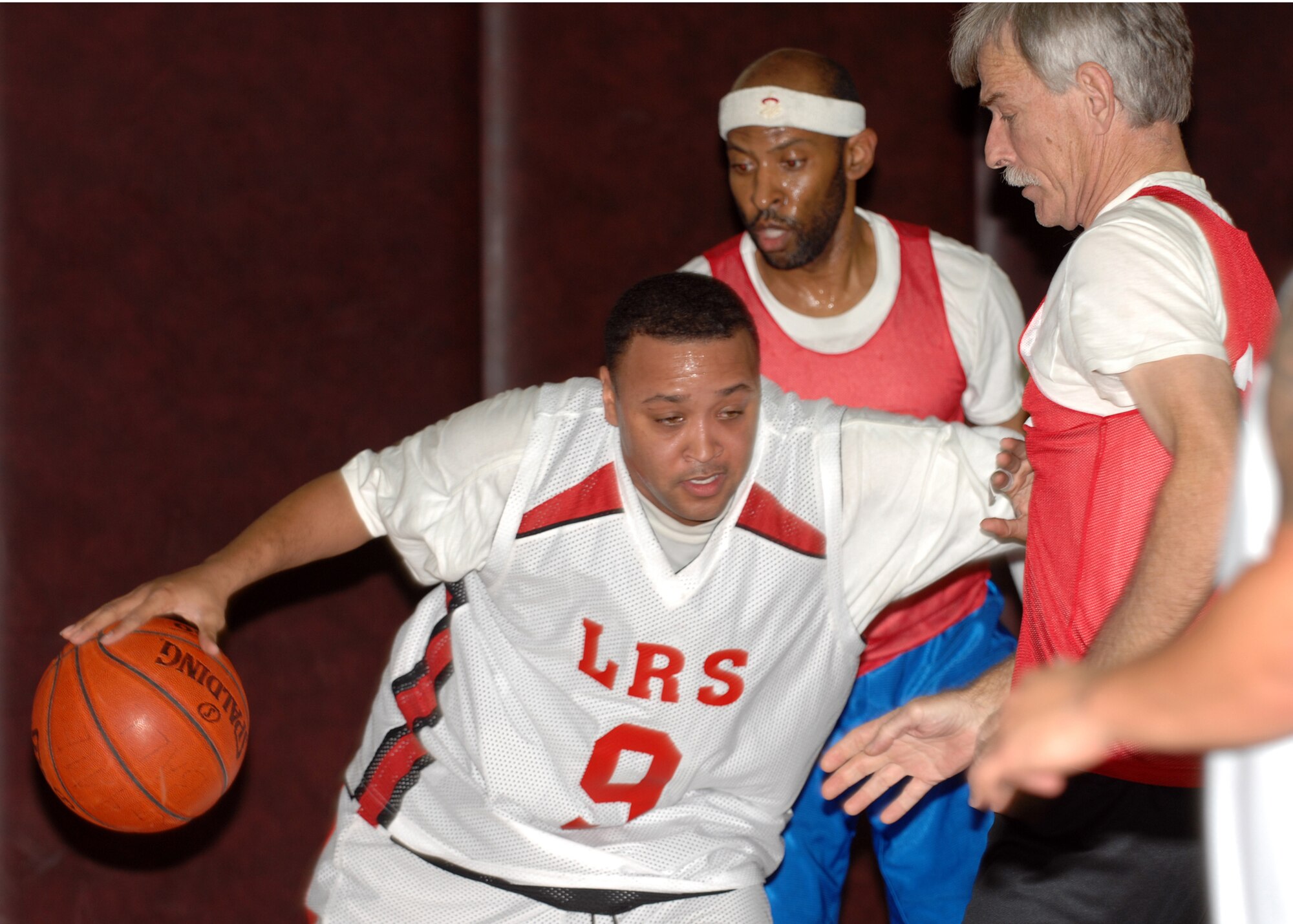 Lamar Dixon, 39th Logists Readiness Squadron guard/forward, defends the ball against Neil Bacon, Department of Defense Dependants School, during an over-30 basketball game Jan. 5 at Incirlik's fitness center. The 39 LRS went on to score a last-second basket allowing them to defeat DoDDs 52-50. (Air Force photo by Staff Sgt. Jeff Nevison)