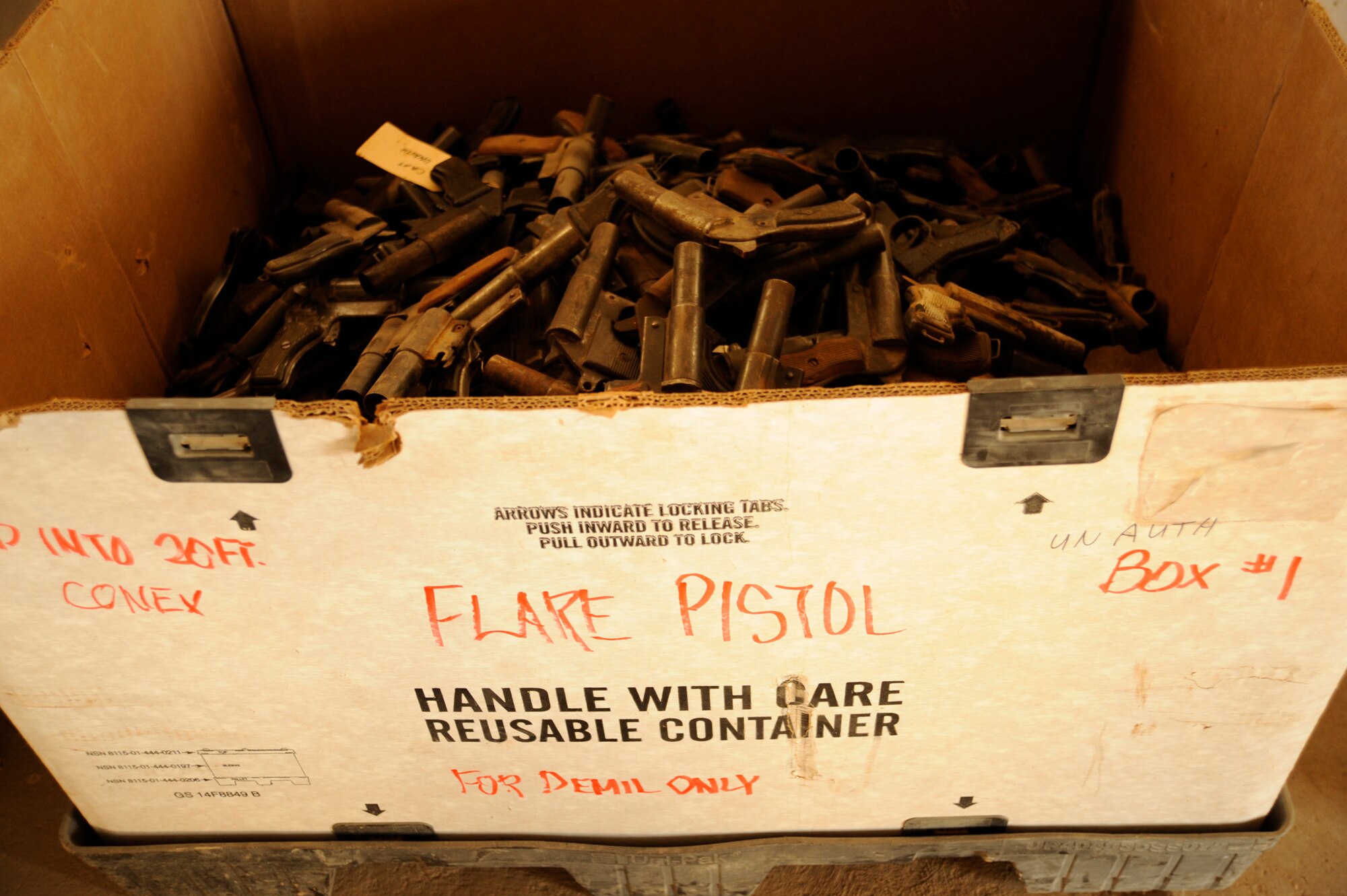 TAJI, Iraq -- A box of captured enemy flare pistols is to be shipped at Taji Military Base, Iraq. All captured enemy weapons are accounted for before getting destroyed. AK-47 rifles, knives, and pistol are some of the captured enemy weapons that have been turned in to be destroyed. (U.S. Air Force photo/Staff Sgt. Paul Villanueva II)