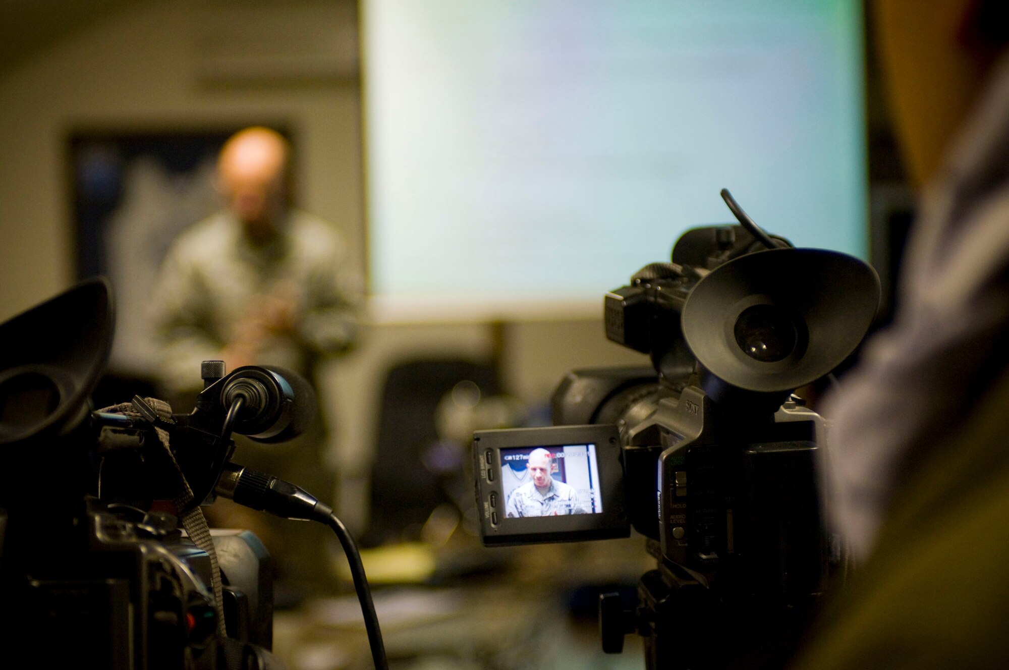 A cameraman captures a close air support briefing from Brig. Gen. Mike Holmes, 455th Air Expeditionary Wing commander, at Bagram Air Field, Afghanistan, Jan. 5. The 455th AEW hosted its first Afghan Media Day in an effort to inform the local populace about the Air Force's role in Afghanistan. (U.S. Air Force photo by Staff Sgt. Samuel Morse)(released)