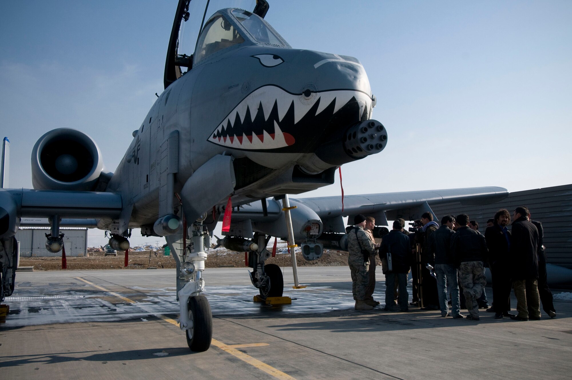 Members of local news agencies are shown around an A-10 Thunderbolt II during Afghan Media Day at Bagram Air Field, Afghanistan, Jan. 5. This was the first time the 455th Air Expeditionary Wing has invited Afghan reporters to learn about the close air support mission. (U.S. Air Force photo by Staff Sgt. Samuel Morse)(released)