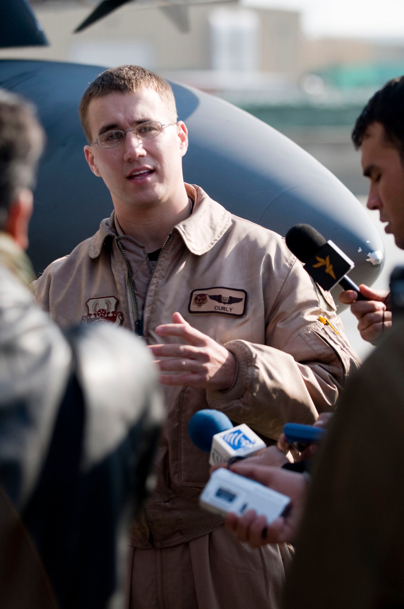 Capt. "Curly," a weapons systems officer, explains some of the features of the F-15E Strike Eagle to a group of Afghan reporters during Afghan Media Day at Bagram Air Field, Afghanistan, Jan. 5. Captain "Curly" said "anytime you can get people out here and show them what we do is a good thing." (U.S. Air Force photo by Staff Sgt. Samuel Morse)(released)