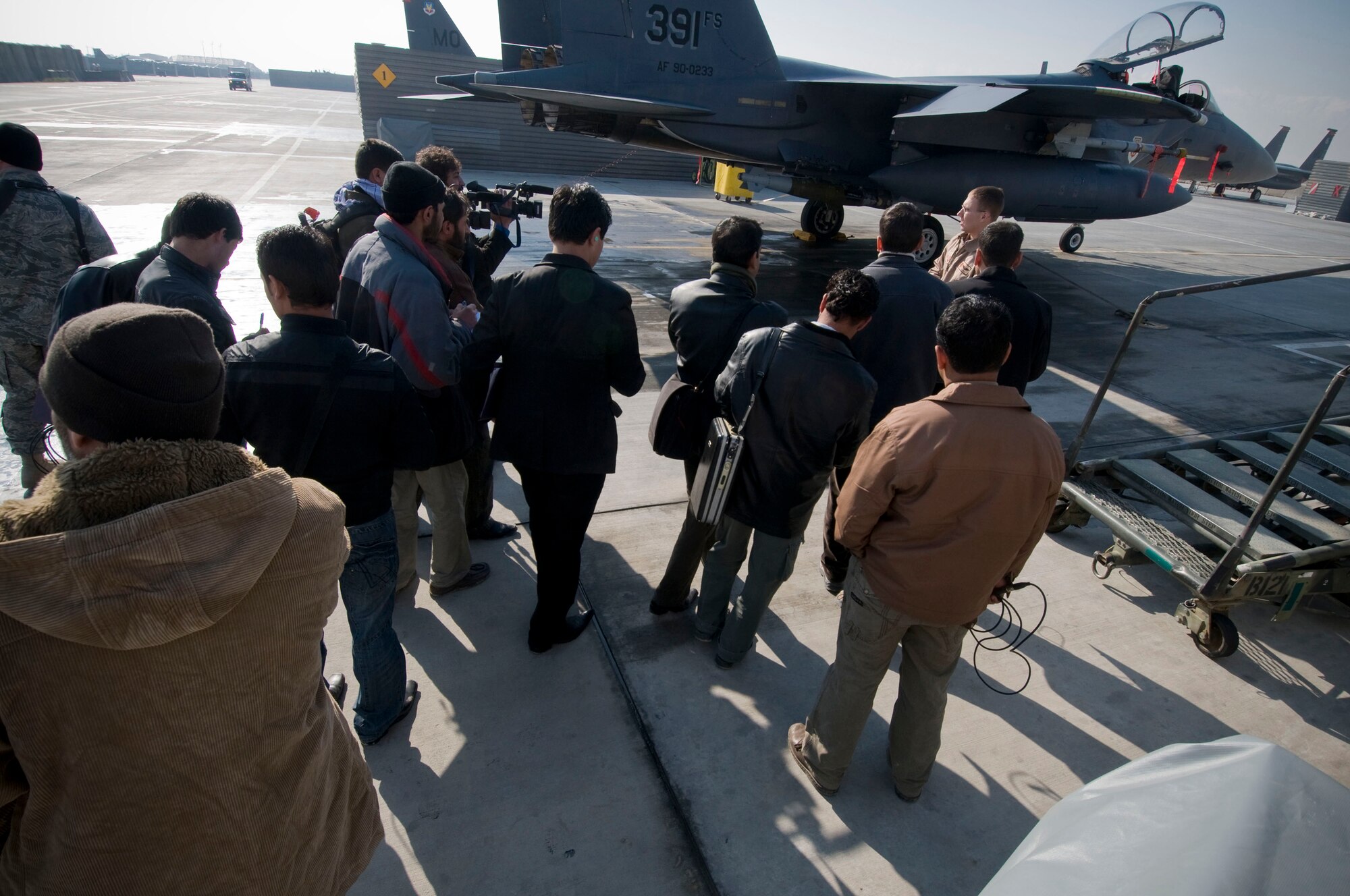 Members of the Afghan media gather for a tour of the F-15E Strike Eagle at Bagram Air Field, Afghanistan, Jan. 5. Fourteen members of Afghan news agencies attended the first 455th Air Expeditionary Wing Afghan Media Day to learn more about close air support. (U.S. Air Force photo by Staff Sgt. Samuel Morse)(released)