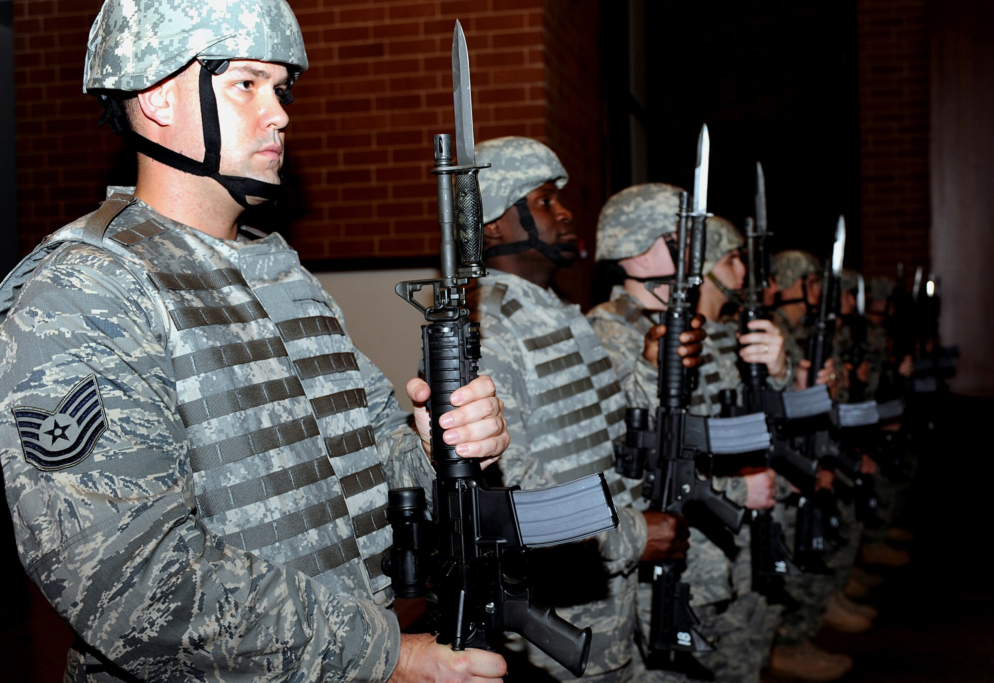 Tech. Sgt. Dan Koenigsmann (foreground), security forces NCO from the U.S. Air Force Expeditionary Center's 421st Combat Training Squadron, stands in a formation of more than 20 security forces Airmen during the Order of the Bayonet induction ceremony Nov. 24, 2008, for Master Sgt. Jason Parker in the USAF EC's Grace Peterson Hall on Fort Dix, N.J.  Sergeant Parker, now stationed at the 92nd Security Forces Squadron at Fairchild Air Force Base, Wash., was nominated for the award while serving as a member of the Expeditionary Center's 421st Combat Training Squadron.  (U.S. Air Force Photo/Staff Sgt. Nathan Bevier)