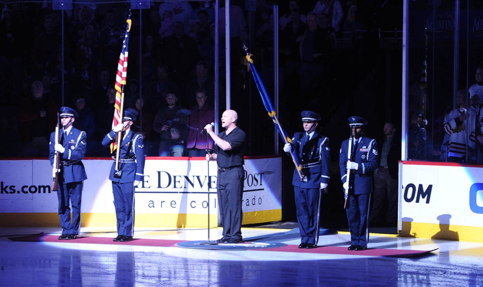 DENVER -- Buckley Air Force Base Honor Guard members, Airman 1st Class' Justin Donnenwerth, Brennen Bogle, Senior Airman Zachary Parker and Staff Sgt. Emmanuel Guerrier post the colors as the Star Spangled Banner is sung before the Colorado Avalanche faced off against the Chicago Blackhawks on military appreciation night at the Pepsi Center, Jan. 8. The team allowed Buckley members to vote on the game they would like to see. (U.S. Air Force photo by Senior Airman Christopher Bush)
