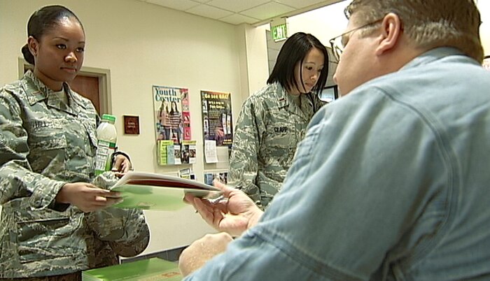2nd Lt. Annabelle Hill, 9th Force Support Squadron, takes a pamphlet from one of the advisors at the financial roadshow Jan. 7. The free roadshow featured briefings by several financial experts, workshops and individual personal financial counselor consultations. (Photo by Karen Savage)