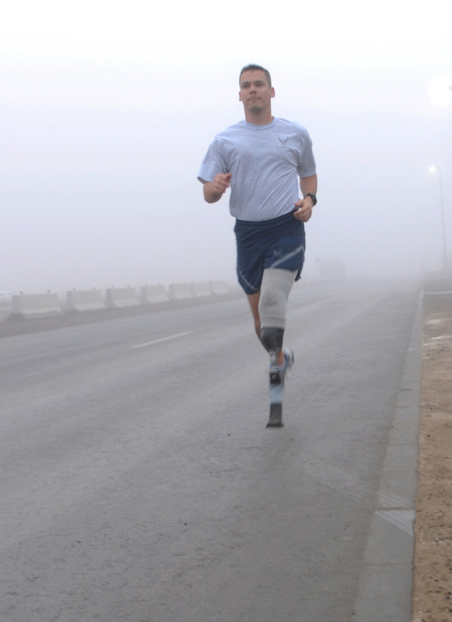 SOUTHWEST ASIA -- Tech. Sgt. Christopher Ramakka, flight chief from the 380th Expeditionary Civil Engineer Explosive Ordnance Flight, goes for an early-morning run here Dec. 24. The Richland, Wash., native is serving his debut deployment after losing his lower left leg when he stepped on a mine in Afghanistan three years ago. He also lost the tips of two fingers and suffered further damage to his hands and right leg. Sergeant Ramakka is depoyed from Lackland Air Force Base, Texas. (US Air Force photo by Tech. Sgt. Denise Johnson) (released)