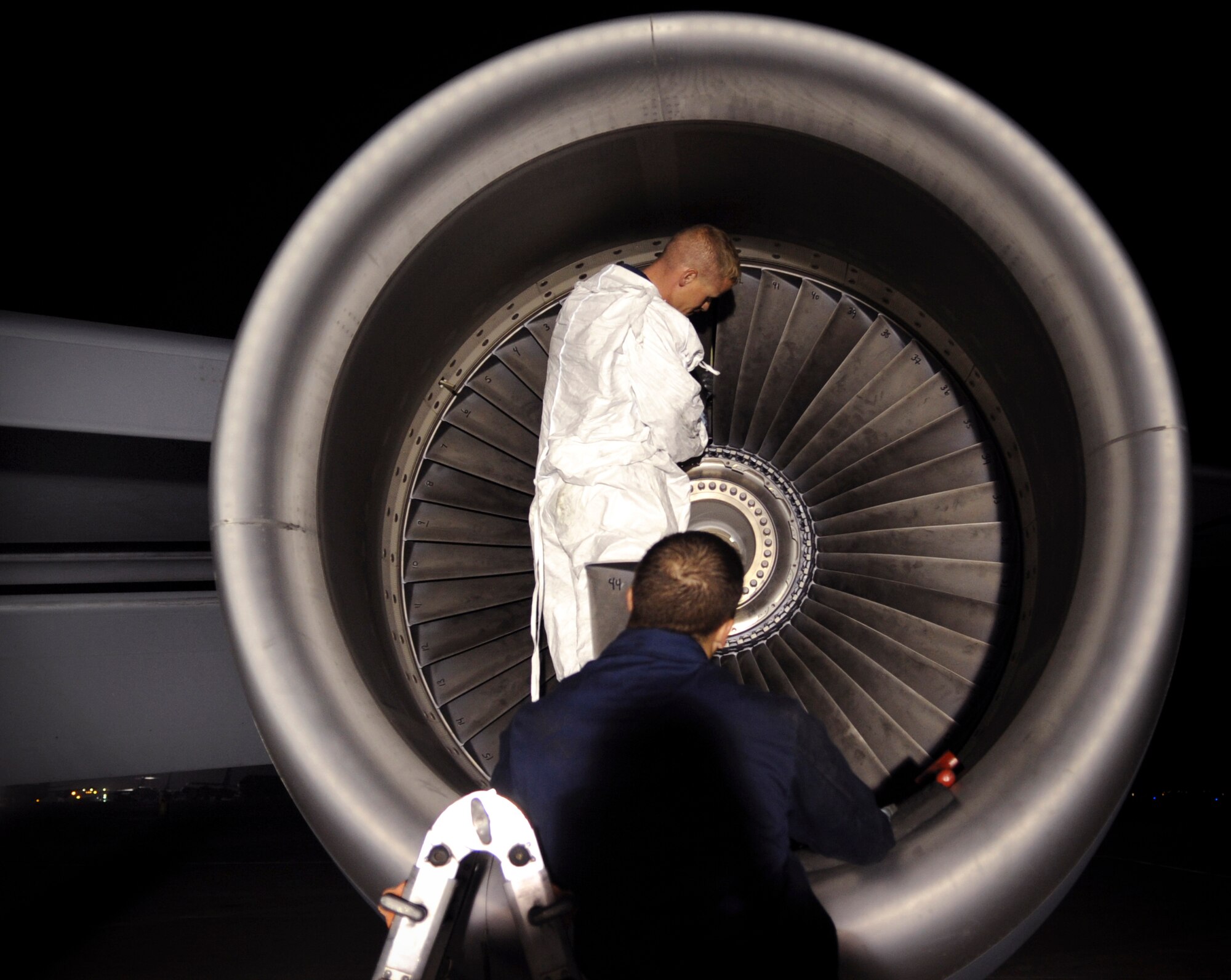 Senior Airman Dale McDowell (on ladder) observes as Tech. Sgt. Marty Davis places the final blades of a fan assembly back into a KC-135 Stratotanker engine after performing a 1,500-hour inspection on the aircraft Jan. 8 at an air base in Southwest Asia. After every 1,500 hours of flight time the blades are removed and inspected to ensure the engine will operate properly.  The two maintainers are assigned to the 340th Aircraft Maintenance Unit.  Airman McDowell is deployed from MacDill Air Force Base, Fla., and Sergeant Davis is deployed from McConnell AFB, Kan.  (U.S. Air Force photo/Staff Sgt. Joshua Garcia)