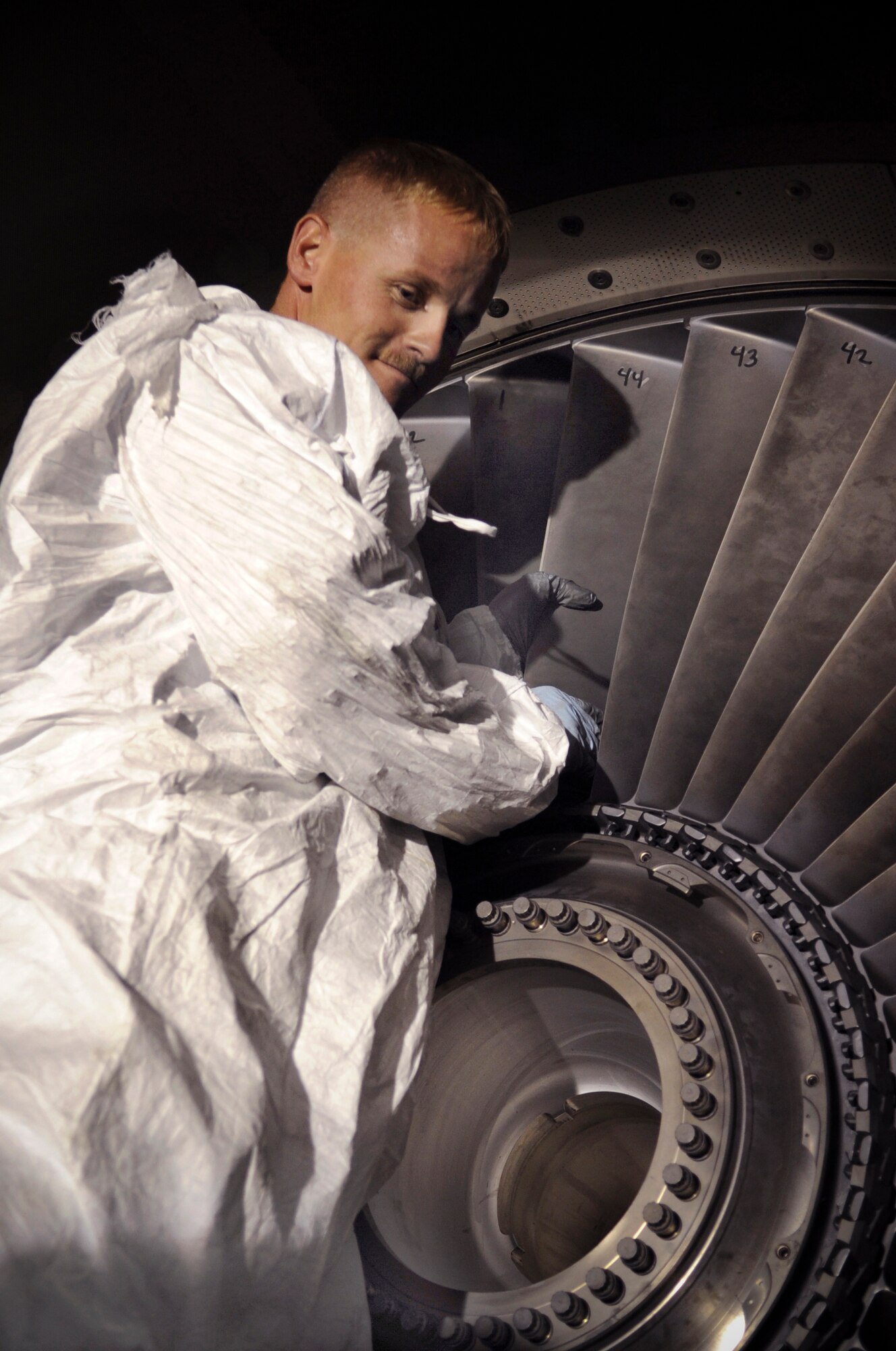 Tech. Sgt. Marty Davis places the final blade of a fan assembly back into a KC-135 Stratotanker engine after performing a 1,500-hour inspection on the aircraft Jan. 8 at an air base in Southwest Asia.  During the inspection the blades are examined for any defects that would prevent the engine from operating properly. Sergeant Davis, assigned to the 340th Aircraft Maintenance Unit, is deployed from McConnell Air Force Base, Kan.  (U.S. Air Force photo/Staff Sgt. Joshua Garcia)