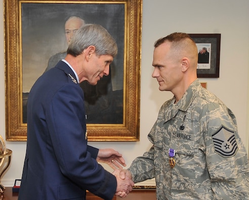 Air Force Chief of Staff Gen. Norton Schwartz congratulates Master Sgt. David Webber Jan. 8 after presenting him the Purple Heart medal in the Pentagon.  (U.S. Air Force photo/Scott M. Ash)