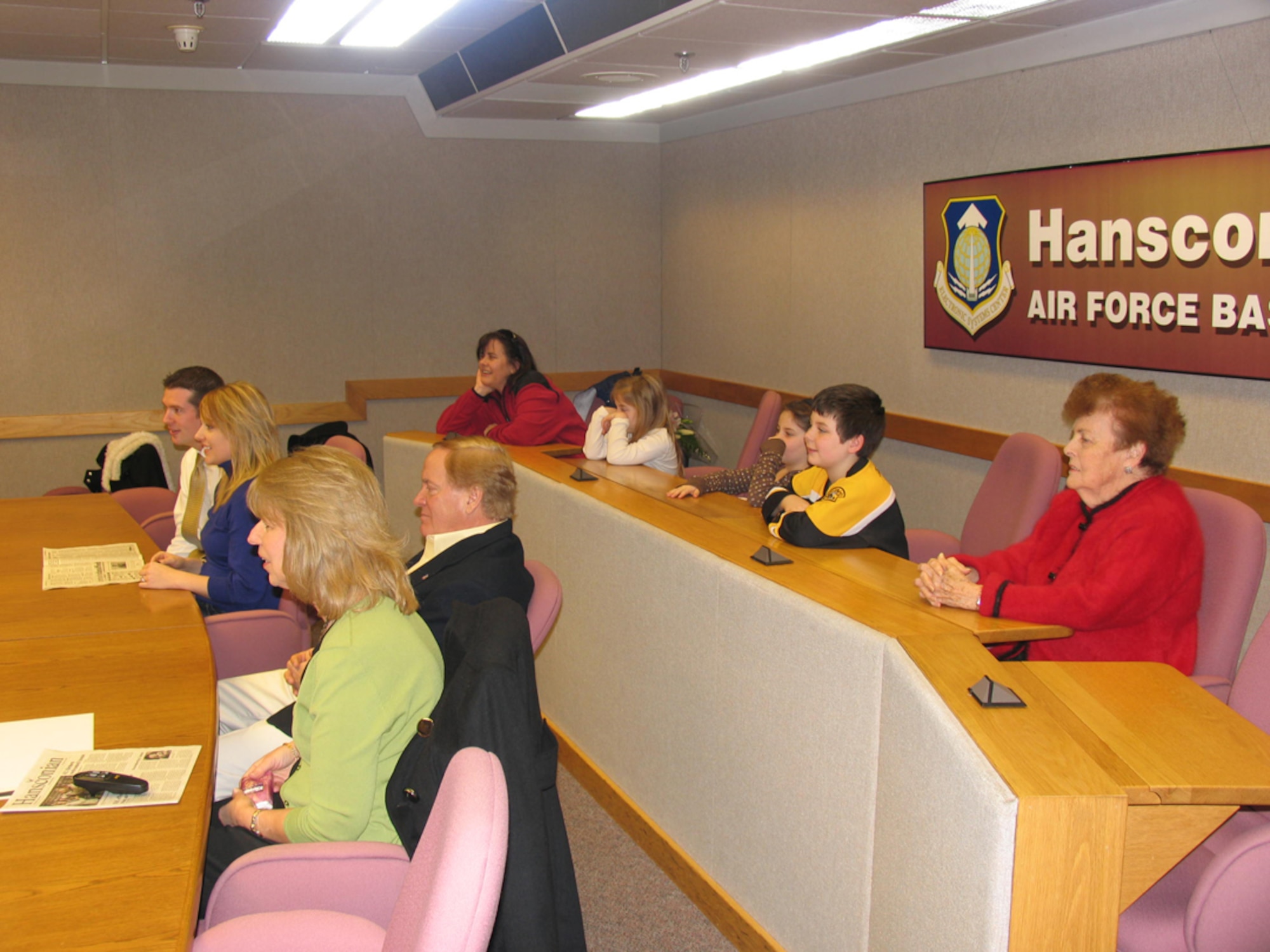 Maj. Ryan Robinson's and Maj. Pete Norton's families watch Major Robinson's promotion ceremony from Hanscom's video teleconference center.  (Photo courtesy of the U.S. Air Force)