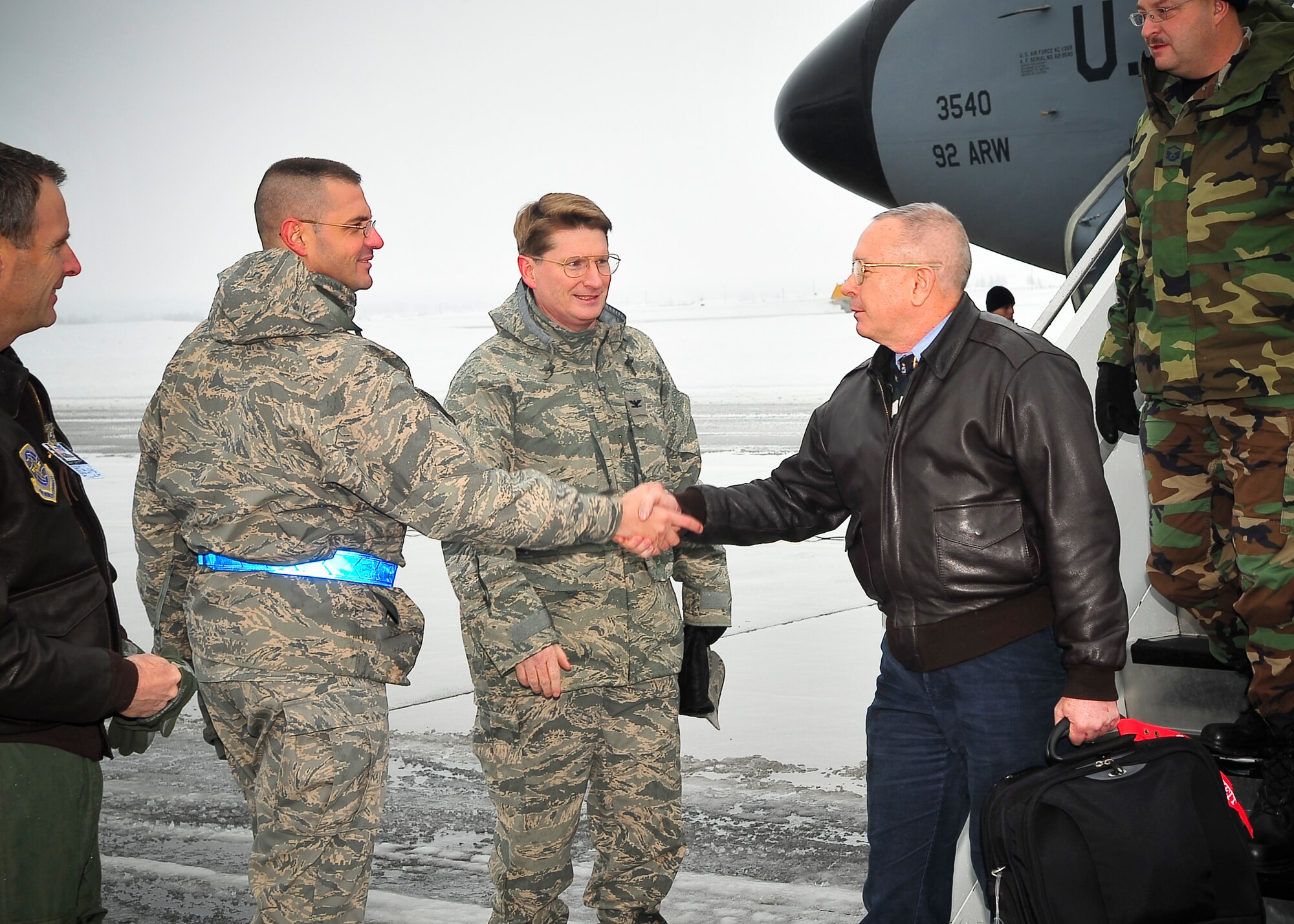 FAIRCHILD AIR FORCE BASE, Wash. – Col. Robert Thomas, 92nd Air Refueling Wing commander, and Chief Master Sgt. David Nordel, 92nd ARW command chief, greet Staff Assistance Visit team leader Bruce Ferrell, Jr., and other SAV members from Air Mobility Command headquarters, Scott Air Force Base, Ill., here Jan. 7. The team will focus on assisting Fairchild to prepare for the upcoming Operational Readiness Inspection in March during their four day stay at Fairchild. (U.S. Air Force photo / Senior Airman Joshua K. Chapman