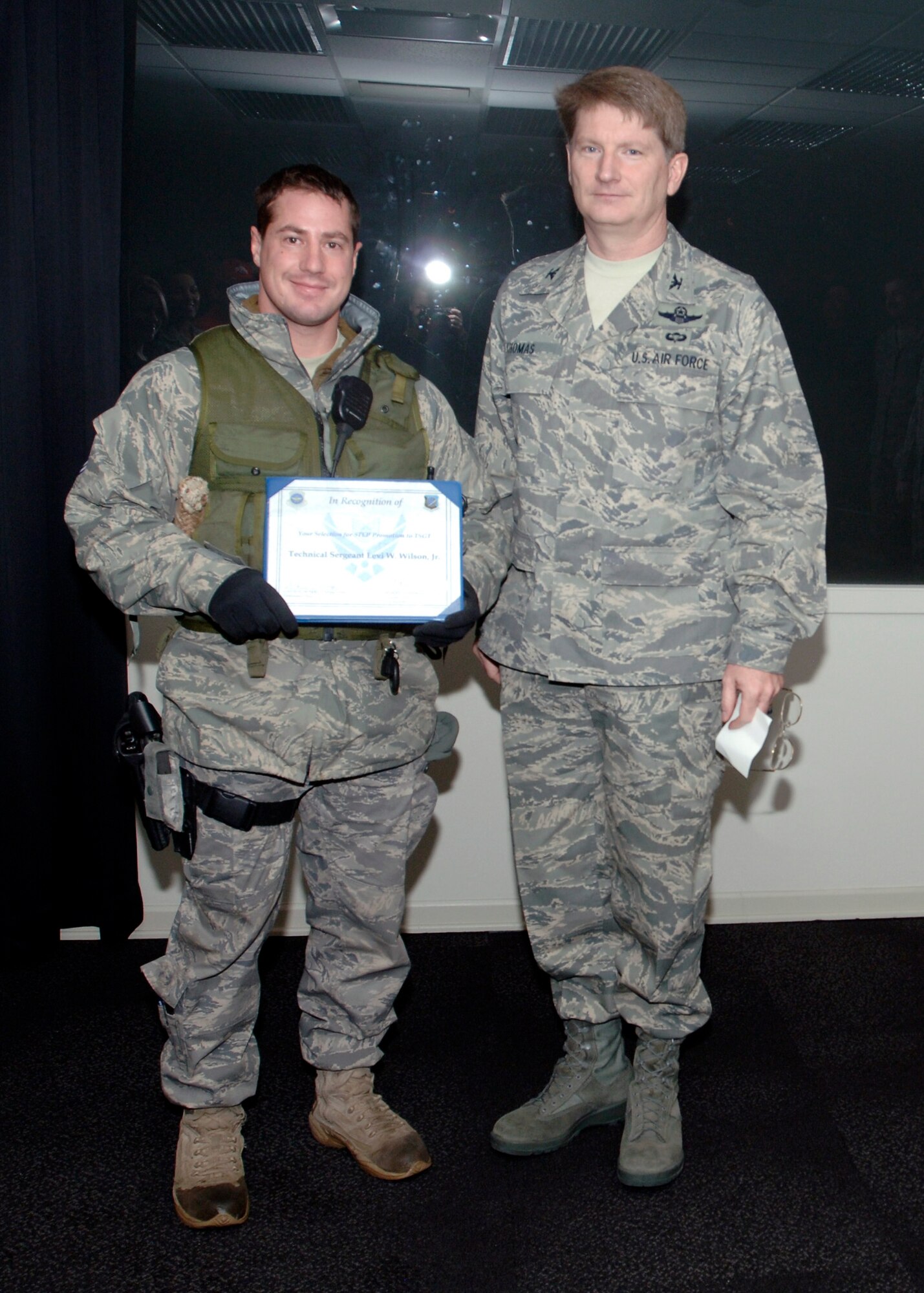 FAIRCHILD AIR FORCE BASE, Wash. – Col. Robert Thomas, 92nd Air Refueling Wing commander, presents Tech. Sgt. Levi Wilson, 92nd Security Forces military working dog handler, with his STEP promotion certificate at the base conference room Dec. 24. (U.S. Air Force photo / Airman 1st Class Melissa Barnett)