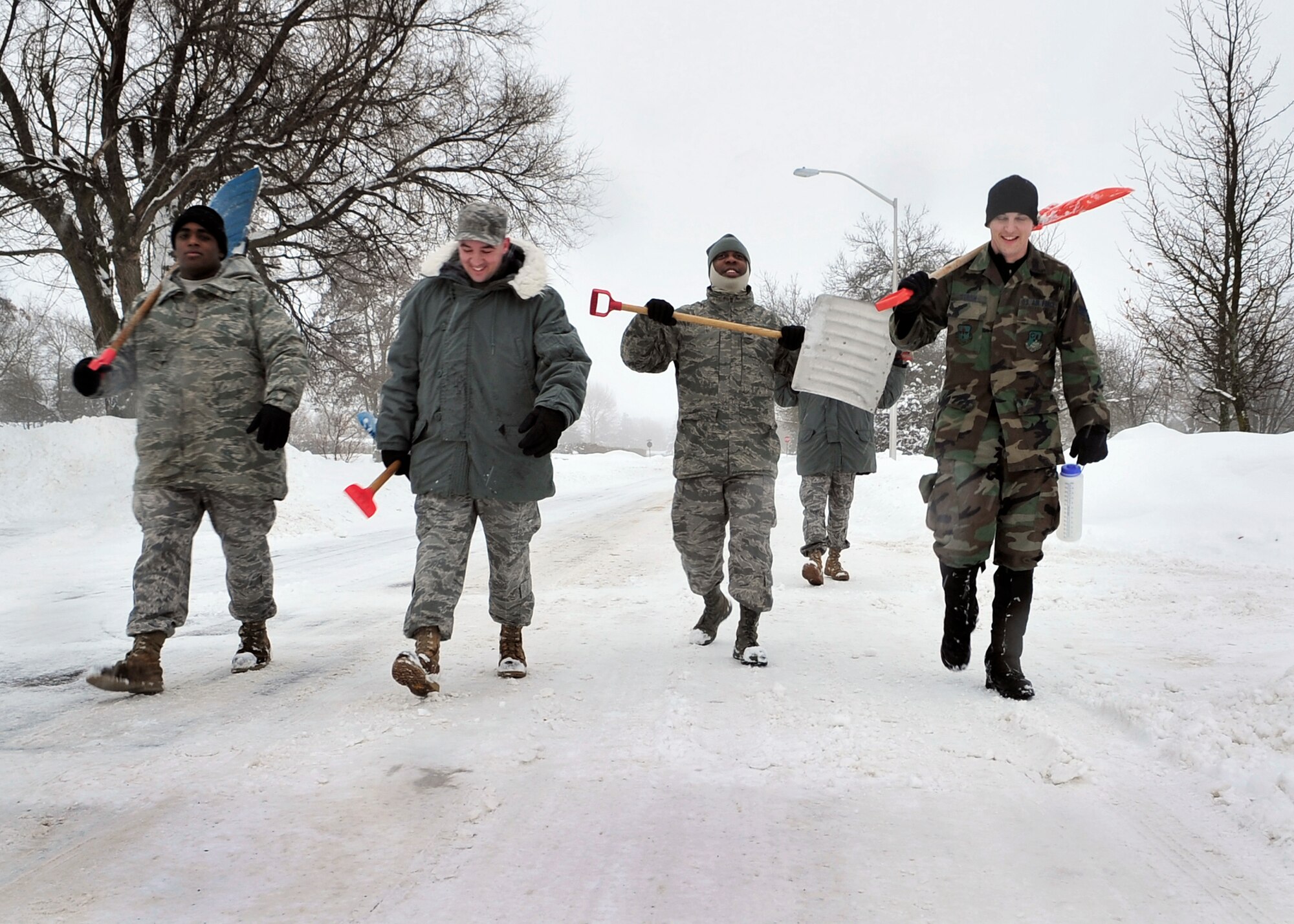 FAIRCHILD AIR FORCE BASE, Wash. – A small group of Fairchild Airmen walk toward their next project site after clearing a fire hydrant across from the base chapel Jan. 6. The group, one of the many tasked throughout the base, cleared all the hydrants on Fairchild allowing easy emergency access for Fire Department personnel. Team members pictured (from left to right): Airman 1st Class Earl Clark, 92nd Maintenance Squadron; Senior Airman Joshua Strom, 92nd Air Refueling Wing chaplain’s assistant; Staff Sgt. James May, 92nd Air Refueling Wing; and Staff Sgt. Mathew Freeborn, 92nd Air Refueling Wing. (U.S. Air Force photo / Senior Airman Joshua K. Chapman)