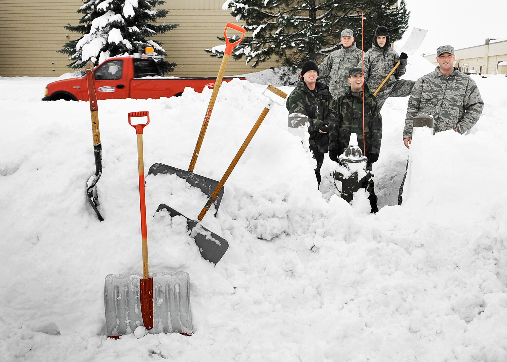 FAIRCHILD AIR FORCE BASE, Wash. – Team members from squadrons throughout the base pose momentarily for a photo in front of a fire hydrant located at the Auto Hobby Center here Jan. 6. The group is one of many tasked with digging out all of the snowed-over hydrants throughout the base. Pictured is Staff Sgt. Kerry Kessler, 92nd Maintenance Squadron; Senior Airman Dean Sanderson, 92nd Air Refueling Squadron; Senior Airman Dwight Miller, 92nd Air Refueling Squadron; Airman 1st Class Gavin Benoit, 92nd Air Refueling Squadron; and Airman 1st Class Nathaniel Rider, 92nd Operations Squadron. (U.S. Air Force photo / Senior Airman Joshua K. Chapman)