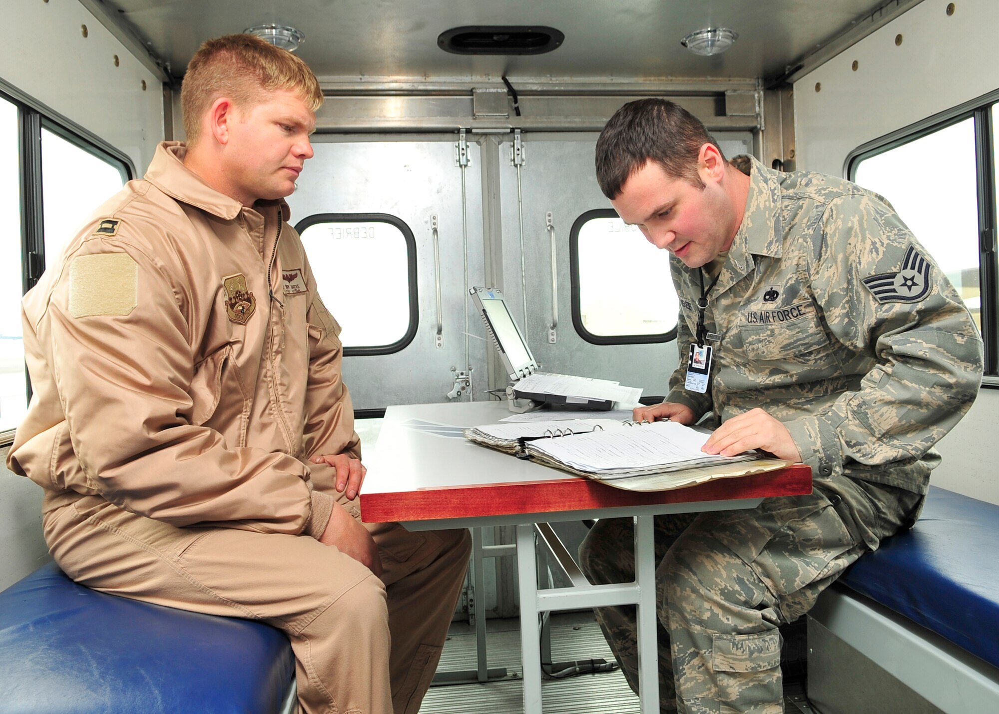 FAIRCHILD AIR FORCE BASE, Wash. – Staff Sgt. Rodney Berubee, 92nd Aircraft Maintenance Squadron mobile debriefer, sits with recently deployed Capt. Ben Bates, 92nd Air Refueling Squadron pilot, to discuss critical flight details upon landing here Jan. 7. Details from the flight are used to gather specific information regarding flight anomalies, allowing flightline maintenance crews to focus on pressing maintenance operations more efficiently and shortening the initial gap in maintenance commencement from 90 minutes to about 20 minutes. “Mobile Debrief enables ground crews to perform maintenance immediately upon aircraft landing,” said Sergeant Berubee. “[It’s] critical for ‘turning’ aircraft to fly another sortie.” (U.S. Air Force photo / Senior Airman Joshua K. Chapman)