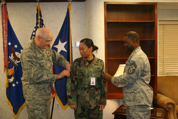 STEPping up In front of co-workers, friends and family, Staff Sgt. Tiare Keith was promoted to technical sergeant Dec. 19 with a STEP promotion by Maj. Gen. Loren M. Reno, Oklahoma City Air Logistics Center commander. General Reno was accompanied by Command Chief Master Sgt. Eric Harmon. Sergeant Keith is the assistant to the OC-ALC chief of Staff. The Stripes for Exceptional Performers program allows commanders to reward a limited number of outstanding Airmen in the ranks of staff sergeant through master sergeant with promotion. (Air Force photo) 