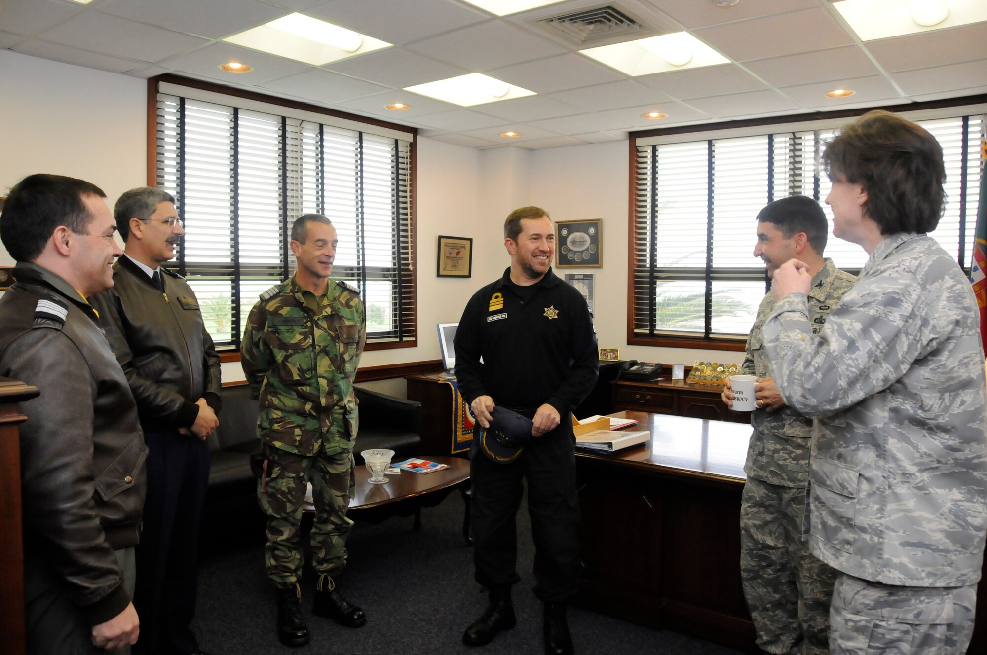 Col. Leonardo Oliveira, Head Quarters Azorean Air Zone chief of staff; Col. Luis Ruivo, Air Base Number 4 commander; Col. Jose Abracos, RG1 commander; and CDR. Joao Goncalves, Port Captain for Angra and Praia, meet with Col. Poore, 65th Air Base Wing commander, and Col. Paul Suarez, 65th ABW vice commander, during their visit to Lajes Field. The group was taken to see a wide range of operations done here, from the 65th Medical Group where they got to see how a U.S. Air Force medical team works and how it partners with the local community, to the 65th Operations Support Squadron, where they could see how flight operations are handled here and how the base works with the Portuguese air force as well as civilian aviation. (U.S. Air Force photo by Guido Melo) 