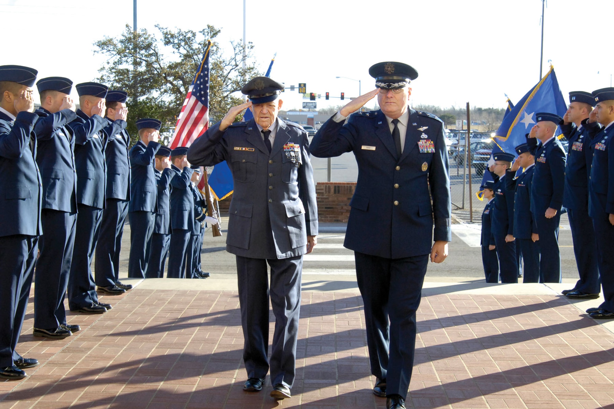Airman honor World War II veteran retired Maj. William “Skipper” McClendon, left, as he and host Maj. Gen. Loren Reno make their way into Bldg. 3001 for a Dec. 29 ceremony recognizing  the Purple Heart awardee’s service.  (Air Force photo by Margo Wright) 
 