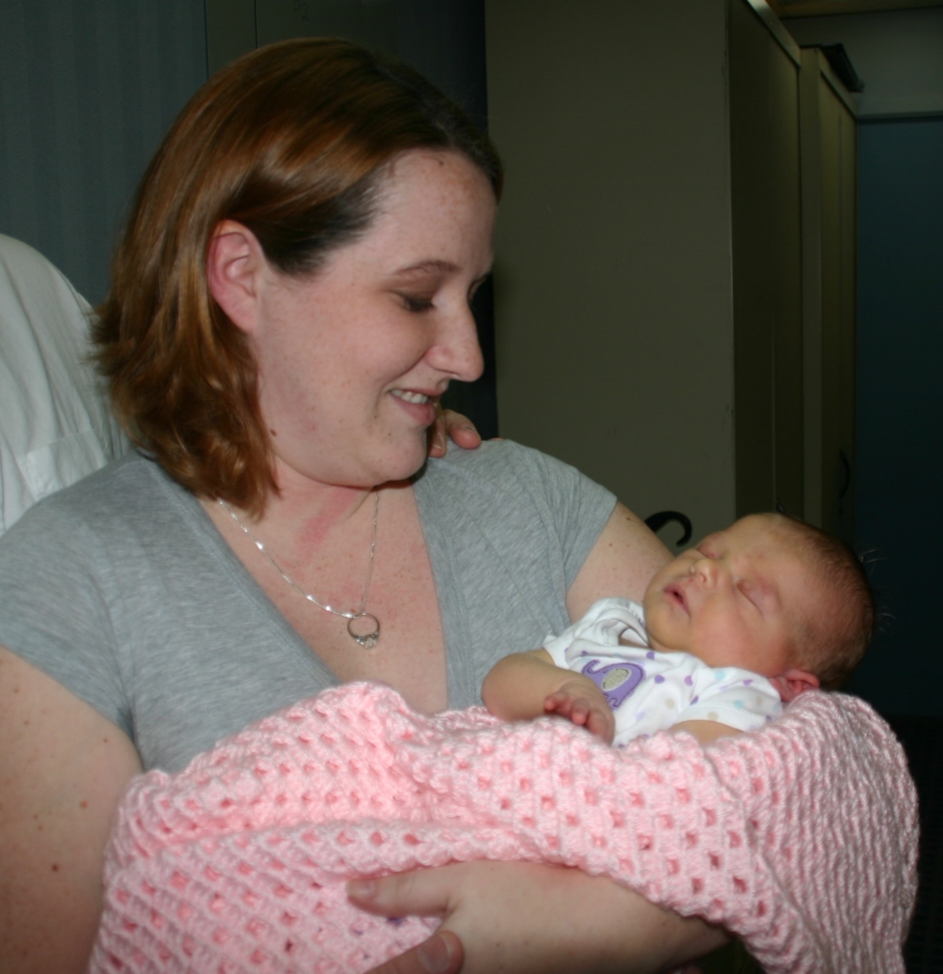 Senior Airman Stephanie Goeders, 552nd Air Control Networks Squadron, looks adoringly at her newborn baby, Emily Anne Goeders, the first baby born in 2009 in the Oklahoma City metro area. Photo courtesy of 1Lt Kinder Blacke.
