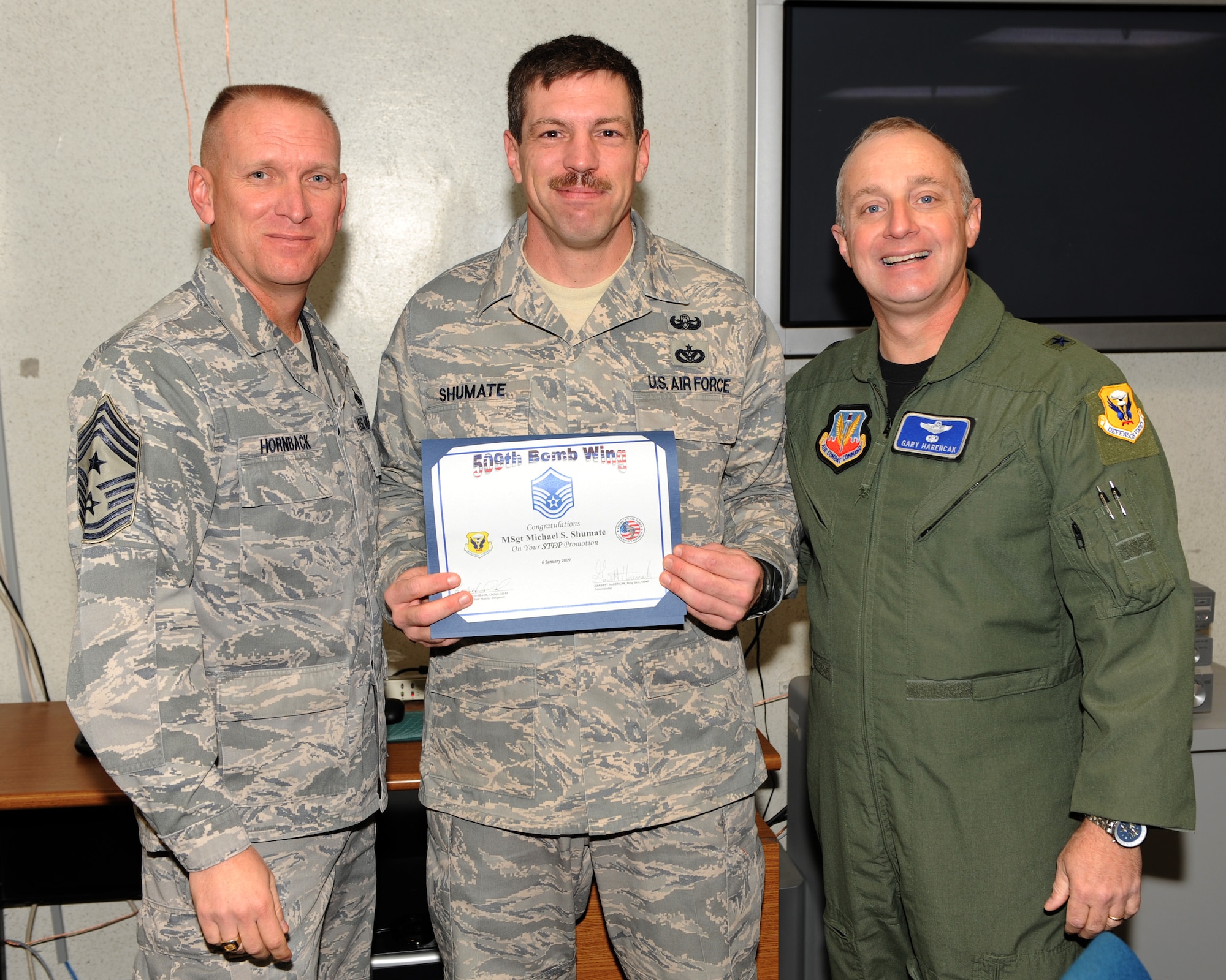 WHITEMAN AIR FORCE BASE, Mo. – Technical Sgt. Michael Shumate , 509th Civil Engineer Squadron, Brig. Gen. Garrett Harencak, 509th Bomb Wing commander and Chief Master Sgt. Brian Hornback, 509th Bomb Wing command chief master sergeant, pose for a photo after Technical Sgt. Michael Shumate receives his Stripes for Exceptional Performance promotion to Master Sergeant Jan. 06. STEP promotions are reserved for staff sergeants to master sergeants, and presented selectees who have had approved recommendations by their commanders and meet the following criteria: candidates have performed outstanding in their duty section, are involved in off-duty activity in local communities, worked on self-improvement, and have been recognized for their job or non-duty performance. (U.S. Air Force photo/Airman 1st Class Carlin Leslie)