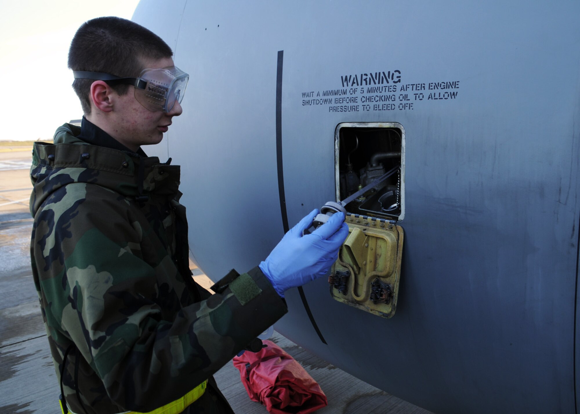 Airman 1st Class Justin Drouin, an aircraft hydraulics system apprentice from the 100th Aircraft Maintenance Squadron, verifies the engine oil level on the number 3 engine of a KC-135 Jan. 6, 2009, at RAF Mildenhall, England. Airman Drouin ensures the oil levels are within proper limits for the engine. (U.S. Air Force photo by Staff Sgt. Jerry Fleshman)