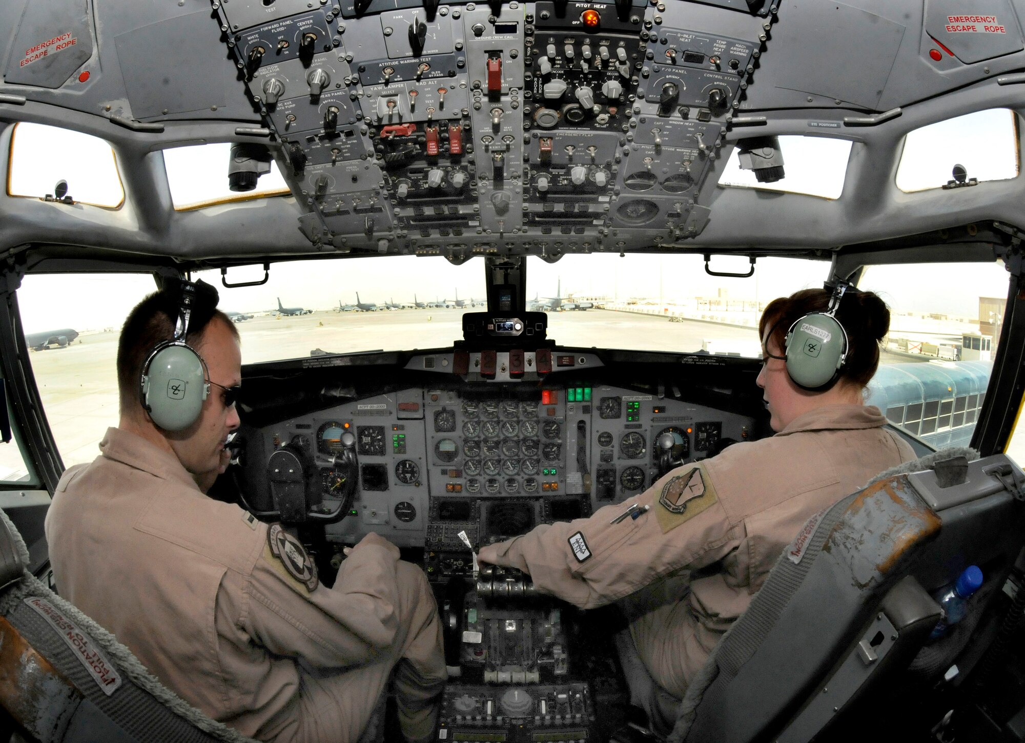 1st Lt. Seth Simpson, Co-pilot assigned to the 7th Expeditionary Airborne Command and Control Squadron and Staff Sgt. Jessica Earls, a flight engineer assigned to the 7 EACCS, perform preflight procedures in the cockpit of the E-8C aircraft Jan. 7, 2009, at an undisclosed location in Southwest Asia.  The Joint Surveillance Target Attack Radar System, or Joint STARS, is an airborne battle management, command and control, intelligence, surveillance and reconnaissance platform.  As a battle management and command and control asset, the E-8C can support the full spectrum of roles and missions from peacekeeping operations to major theater war. Lieutenant Simpson and Sergeant Earl are deployed from Robbins Air Force Base, Ga., in support of Operations Iraqi and Enduring Freedom and Joint Task Force-Horn of Africa.  (U.S. Air Force Photo by Tech. Sgt. Michael Boquette/Released) 