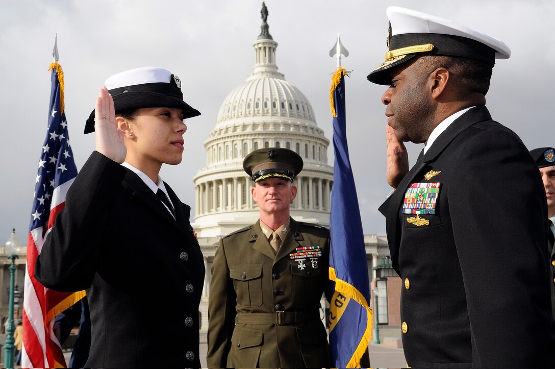 U.S. Navy Rear Adm. Earl Gay, deputy chairman for the Armed Forces Inaugural Committee, administers the oath of enlistment  to Navy Yeoman 2nd Class Sacha Zamora during her re-enlistment ceremony held on the steps of the Capitol Building in Washington, D.C., Dec. 31, 2008. 