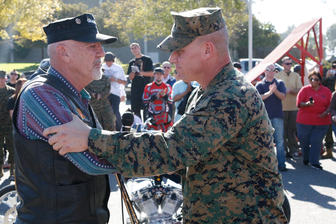 Sgt. Maj. Jeffrey Dixon, Marine Corps Base sergeant major, MCB Camp Pendleton, shakes hands with Marine icon R. Lee Ermey during a motorcycle safety event on Camp Pendleton, Jan. 9. Ermey was there with freestyle motocross riders to promote safety.