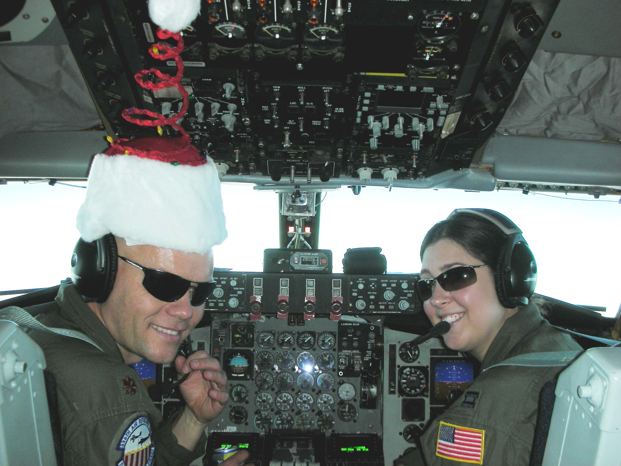 Maj. Brad Herrick and Capt. Mary Guest, both from the 336 ARS, stay in the Christmas spirit as they refuel a C-17 from McChord AFB on Dec. 25. The last of about 130 members from various units throughout March ARB returned here from Incirlik AB, Turkey, Jan. 4, after wrapping up refueling missions in support of operations in Iraq and Afghanistan. Two KC-135s from the 336 ARS conducted 131 sorties and unloaded 1,000,734 pounds of fuel during the two-month deployment. (U.S. Air Force photo courtesy of Capt. Mary Guest)
