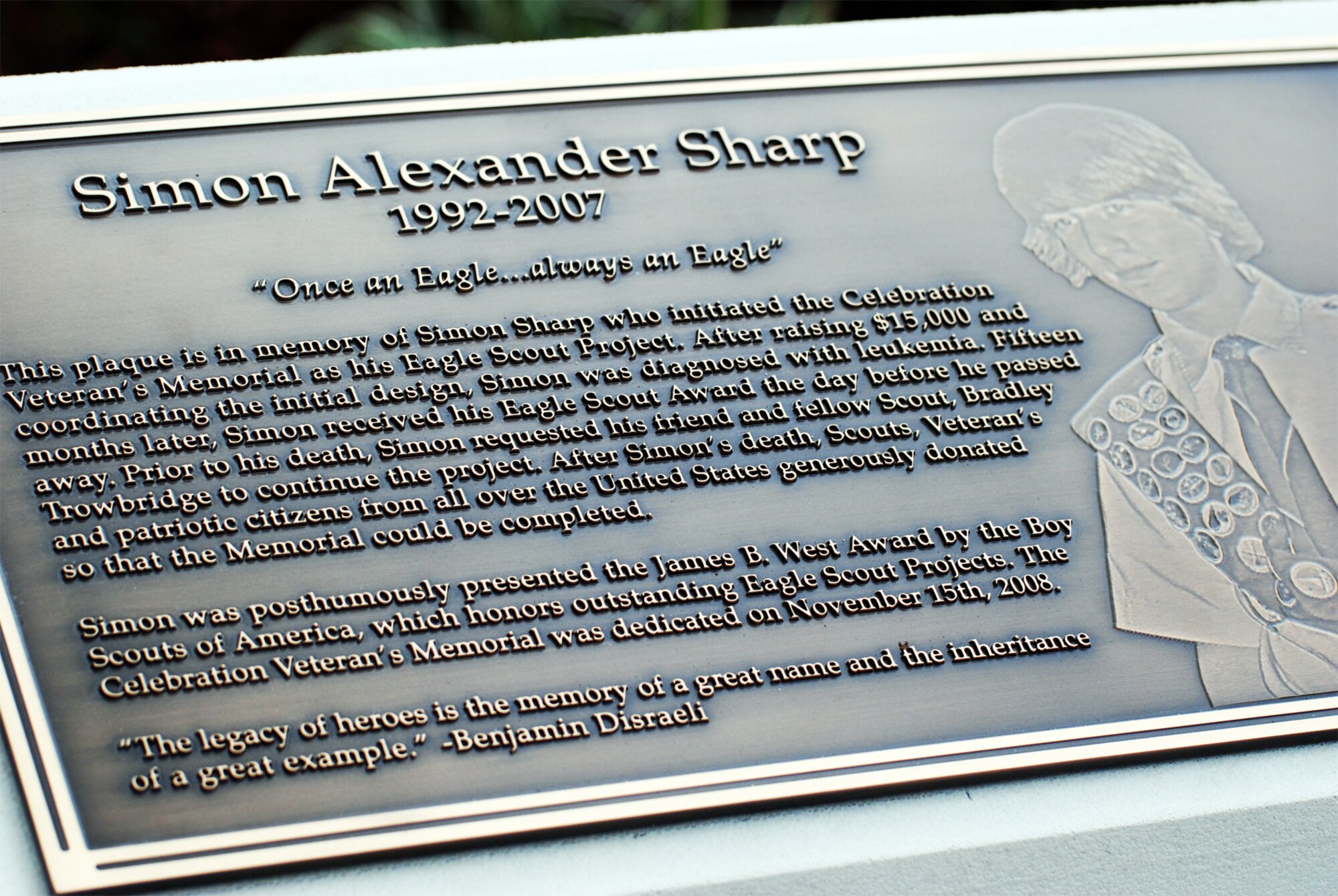 CELEBRATION, Fla. - A tribute to Simon Sharp, the local Eagle Scout who envisioned and began building the Celebration Veteran's Memorial. Simon succumbed to leukemia before the project was completed. Fellow friend and scout Bradley Trowbridge spearheaded the completion effort; the memorial was dedicated one year after Simon's death. (U.S. Air Force photo/Staff Sgt. Heather Kelly)