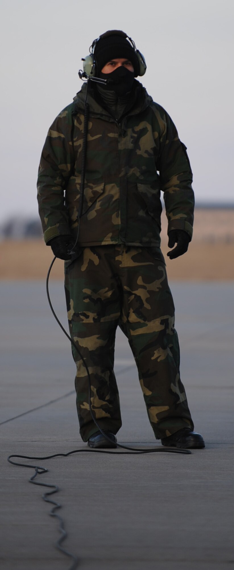 Tech. Sgt. Billy Martin puts his back to an 11-degree wind chill while getting a KC-135 Stratotanker ready for takeoff at McConnell Air Force Base, Kan., early in the morning on Jan. 10. Sergeant Martin is a maintenance crew chief assigned to the 931st Aircraft Maintenance Squadron, an Air Force Reserve unit at McConnell. The tanker he helped prepared was flown by a 931st flight crew in support of the 22nd Air Refueling Wing, the 931st's active-duty host unit at McConnell. More than 25 of the 22nd's newest Airmen flew along to learn more about aerial refueling, the primary mission at McConnell. (U.S. Air Force photo/Tech. Sgt. Jason Schaap)